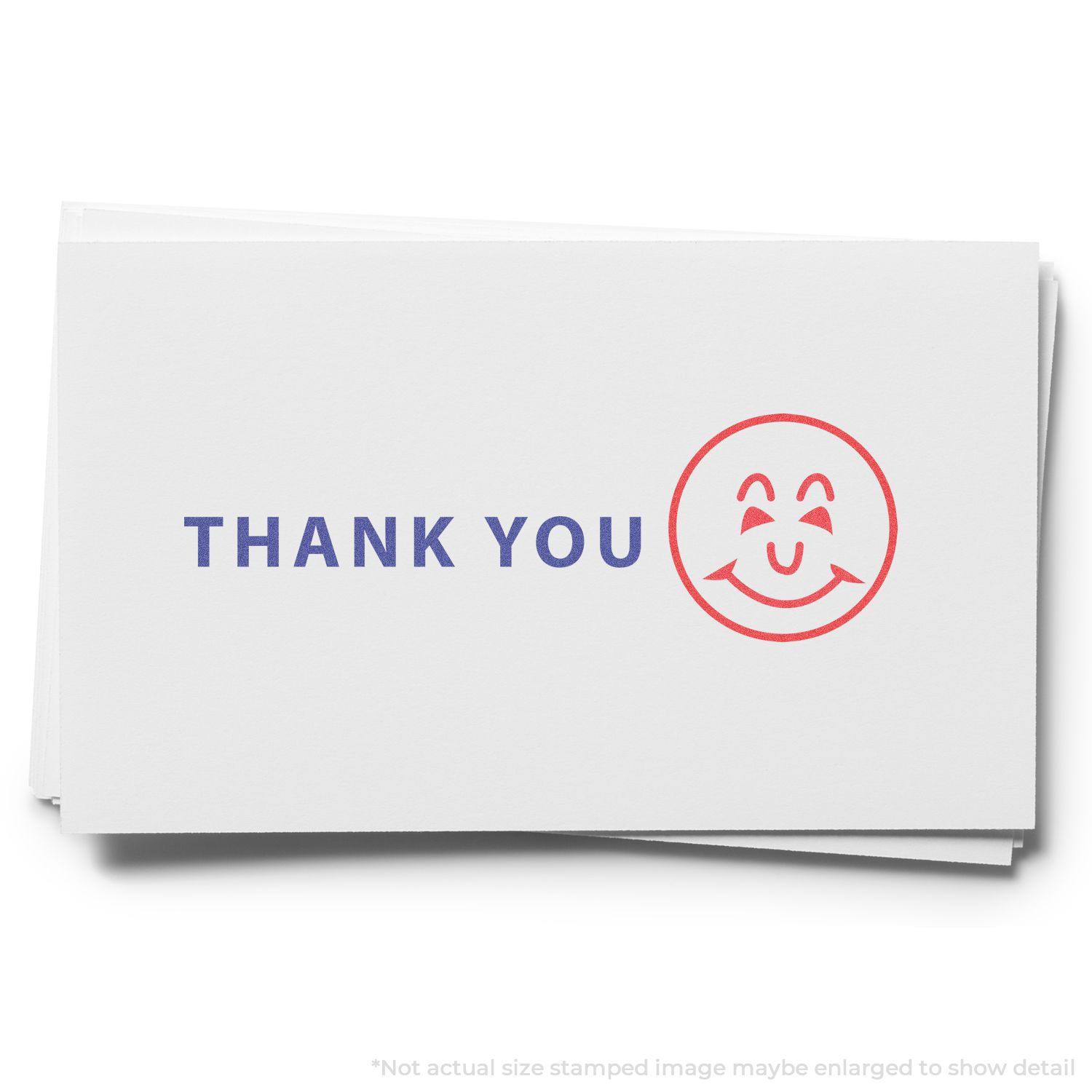 A card stamped with THANK YOU in blue and a red smiley face using the Two-Color Thank You Xstamper Stamp.