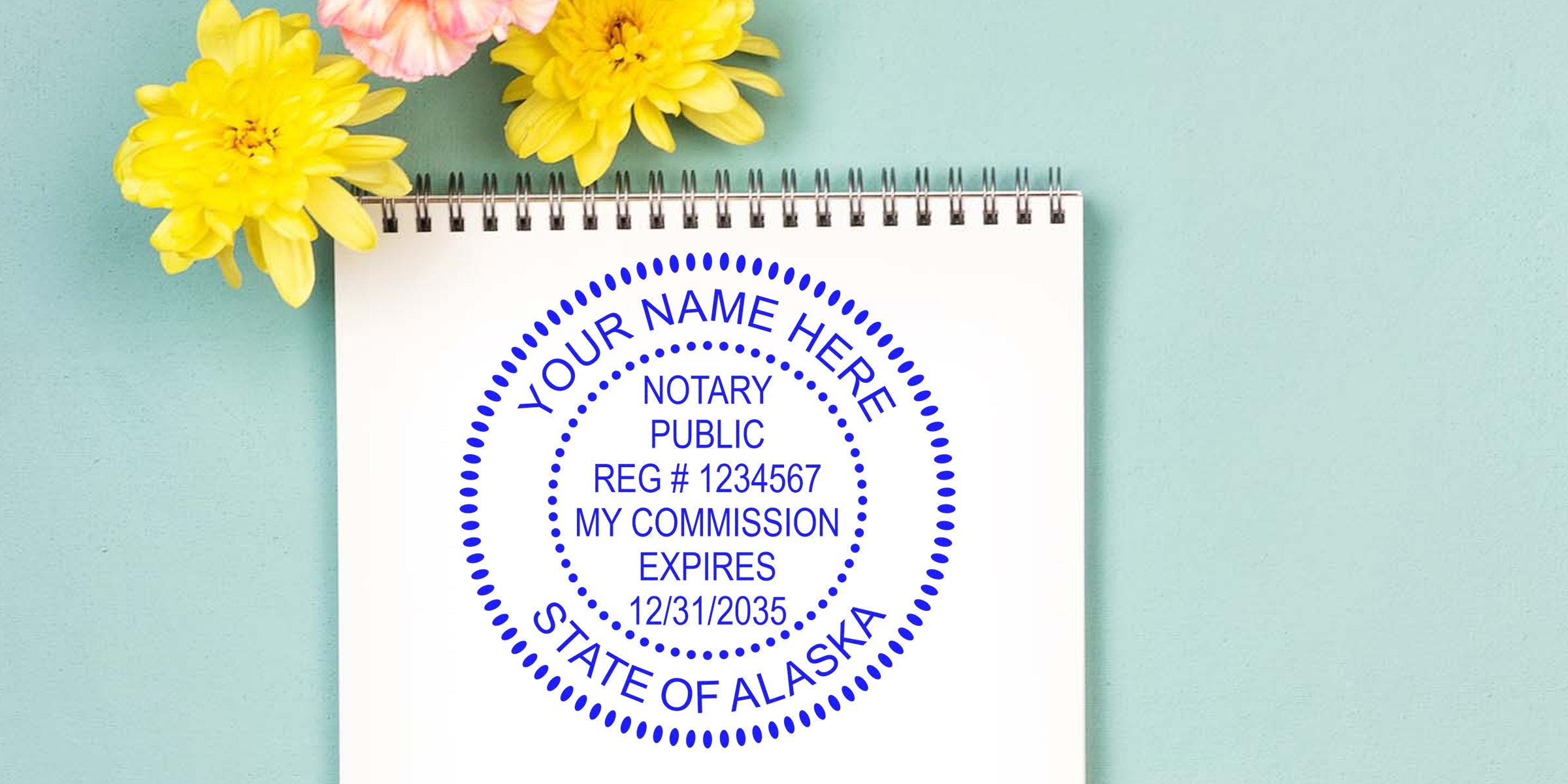 Blue circular Alaska notary public seal stamped on white spiral notepad with yellow flowers on pastel teal background
