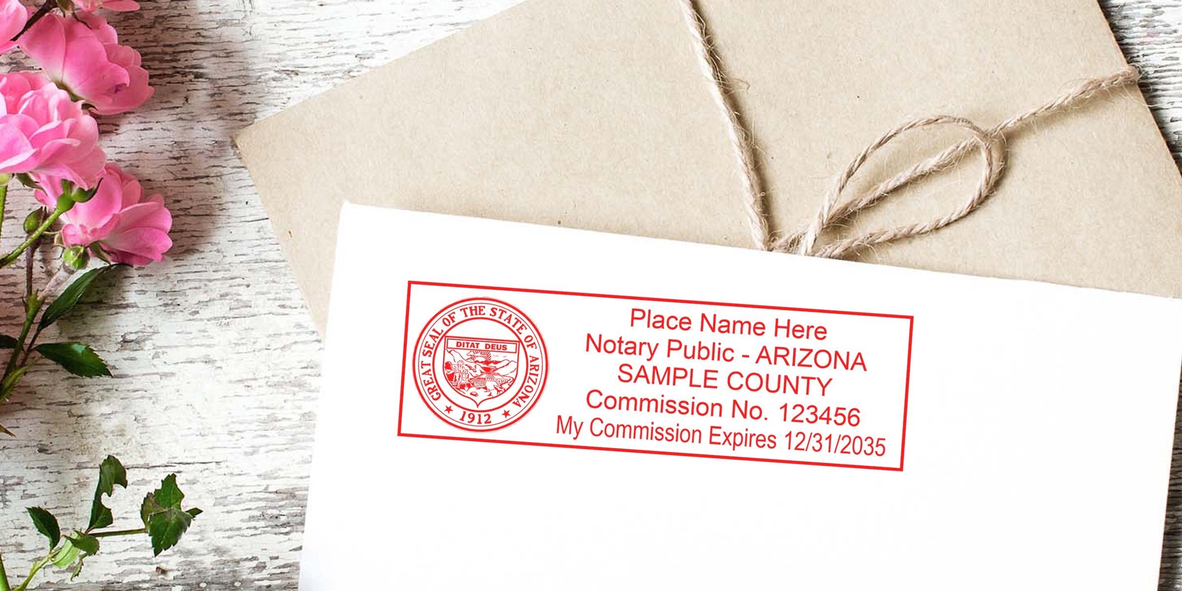 White envelope with red Arizona notary public stamp and state seal, tied kraft package with twine, pink roses on weathered white wood backdrop.