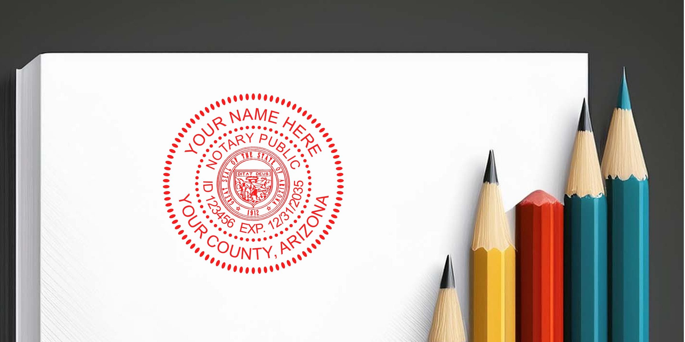 Red circular notary public seal stamped on white paper beside five colored pencils (yellow, red, teal) on a dark background — notary seal mockup for Arizona with customizable name, ID and county.