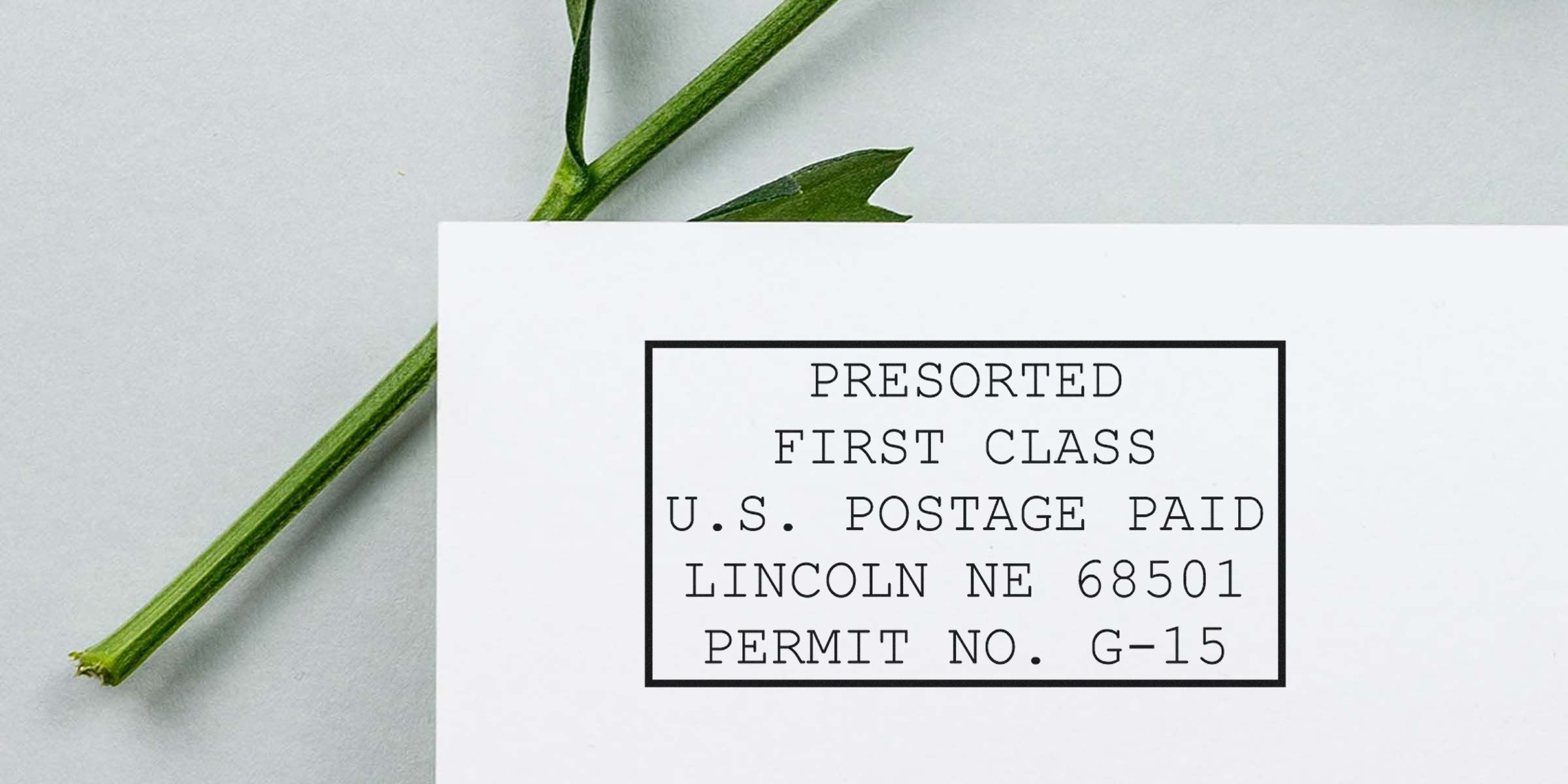 Postcard with a black bordered stamp reading “PRESORTED FIRST CLASS U.S. POSTAGE PAID LINCOLN NE 68501 PERMIT NO. G-15.”