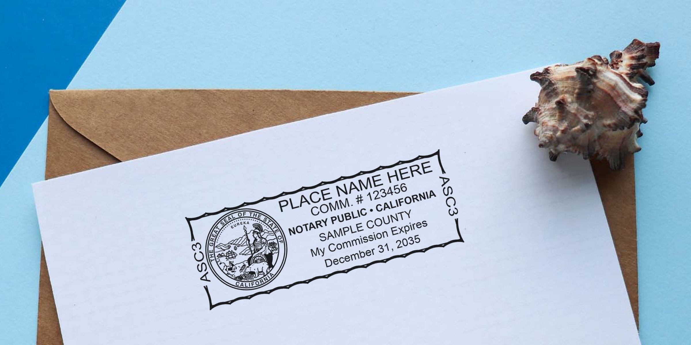 Notary public stamp impression on white paper atop a brown envelope with a seashell, showing a sample California seal, commission number, county name and commission expiration date on a blue background.