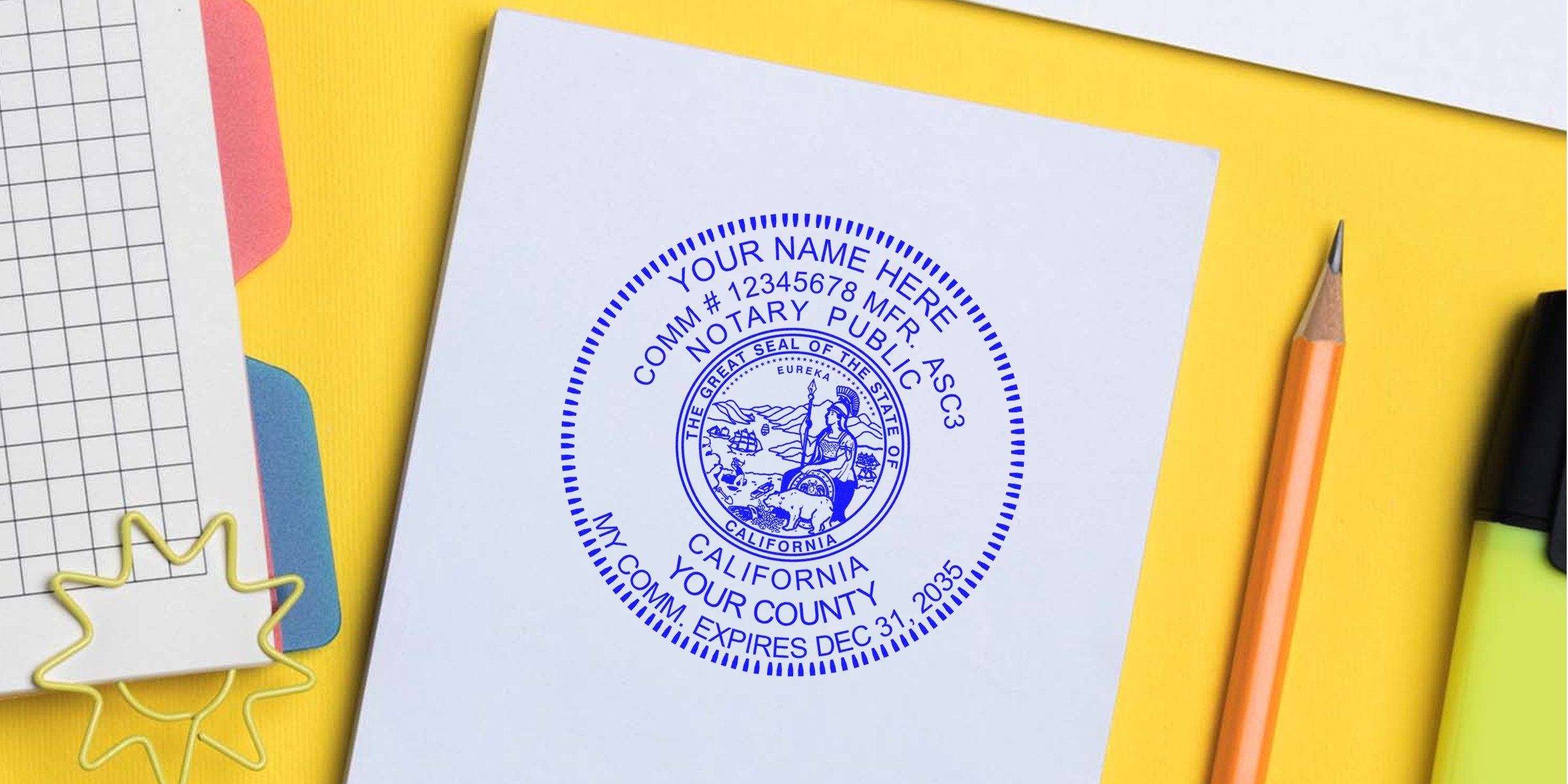 Blue circular California notary public seal stamped on white paper with state emblem, surrounded by pencil, highlighter and grid paper on a yellow desktop — notary seal, notary public stamp, official document verification.
