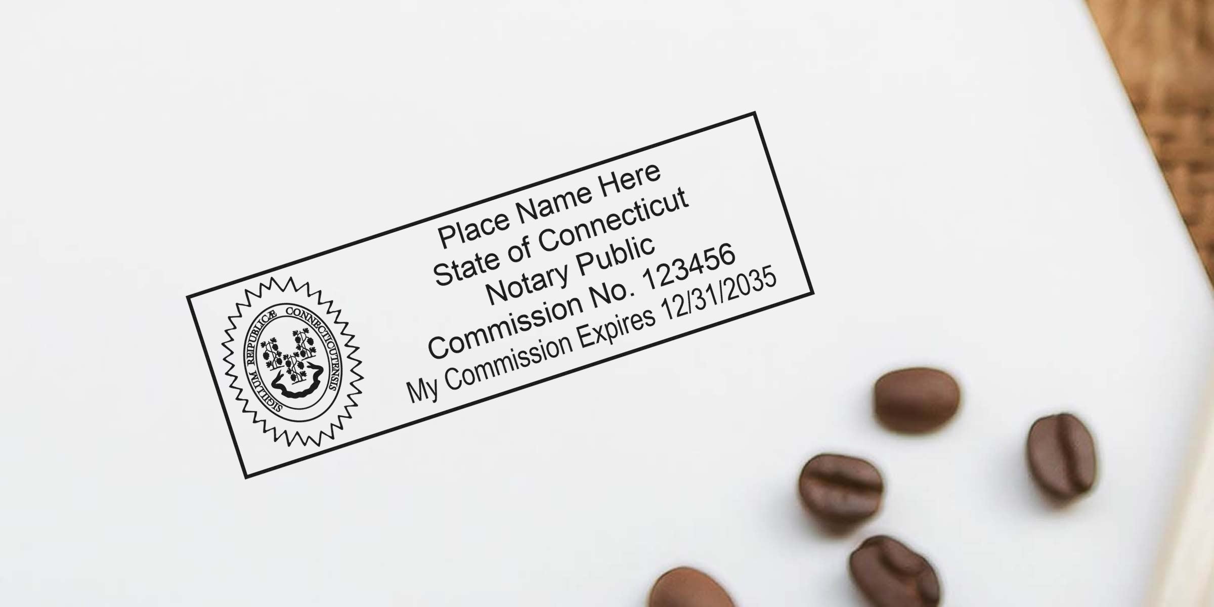 Close-up of Connecticut notary public stamp on white paper reading "Place Name Here, State of Connecticut, Notary Public, Commission No. 123456" with scattered coffee beans