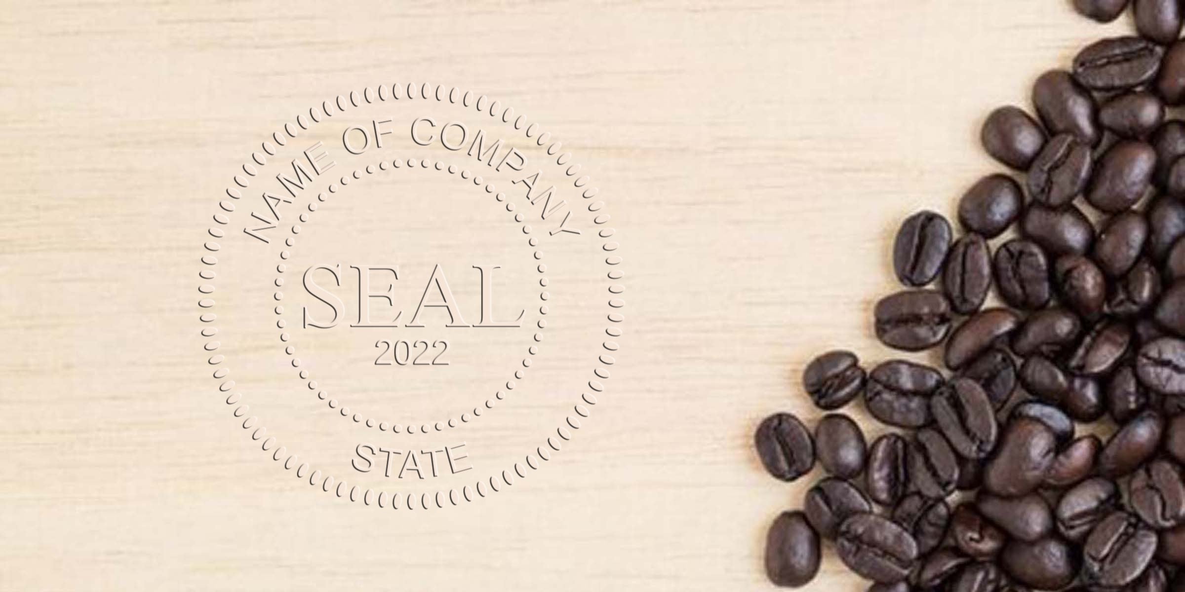 Circular seal reading SEAL 2022 with the words “Name of Company” around the edge, on a light wooden background beside scattered dark coffee beans.