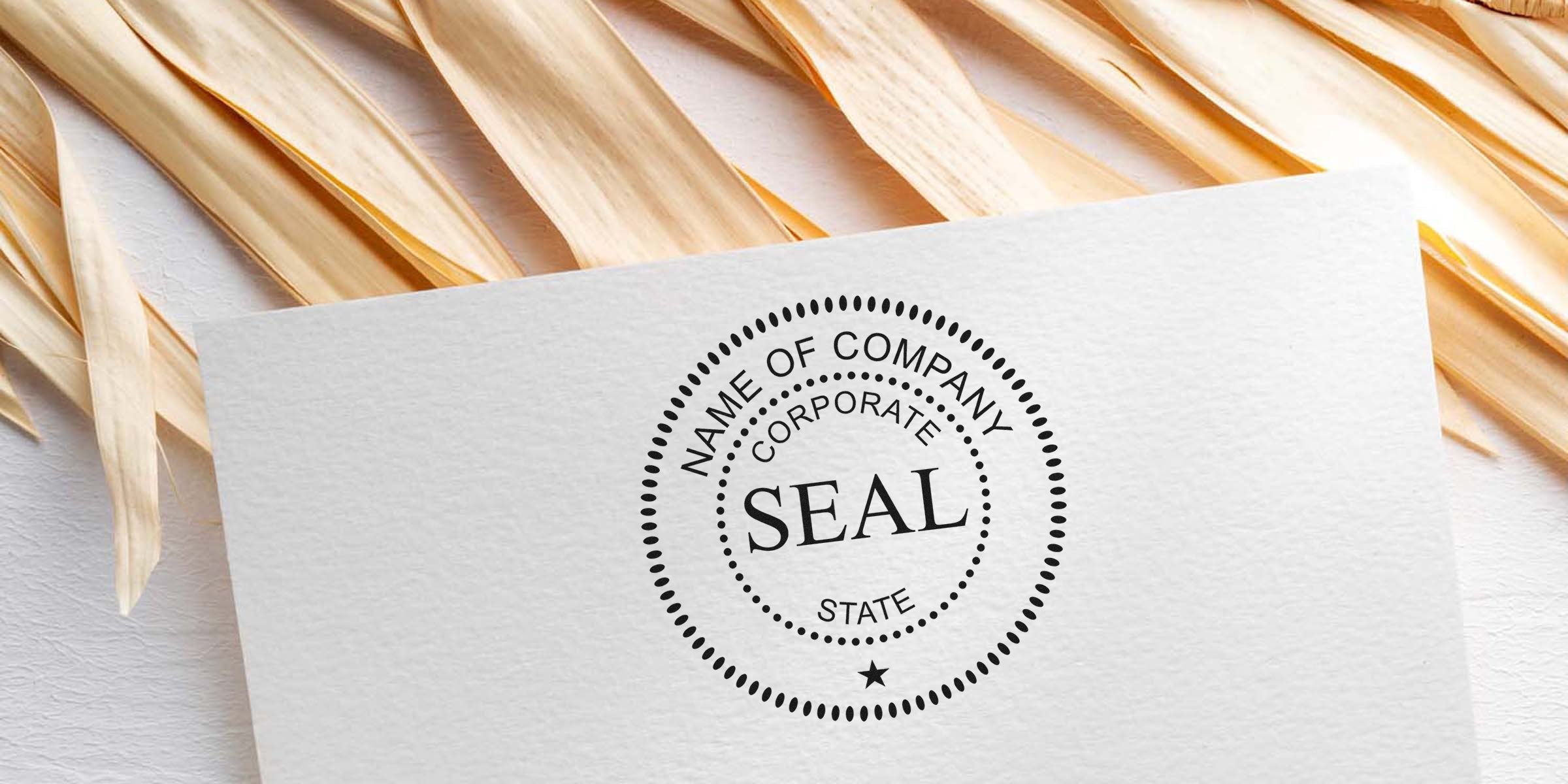 Round black company seal stamp with the word “SEAL” at the center on a white card.