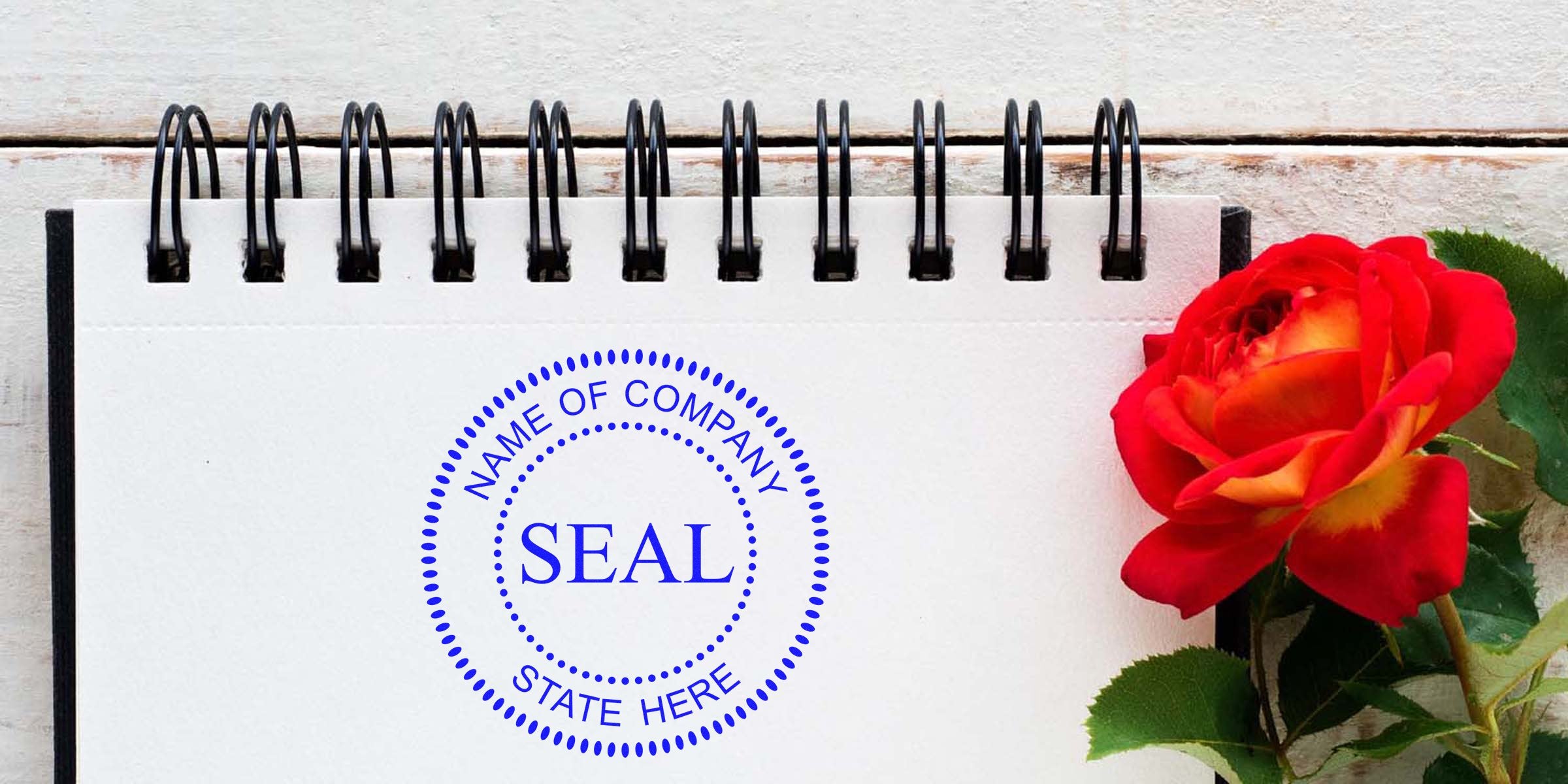 Blue circular seal with the word SEAL and placeholder text “NAME OF COMPANY” and “STATE HERE” on a white notebook page, with a red rose on the right.