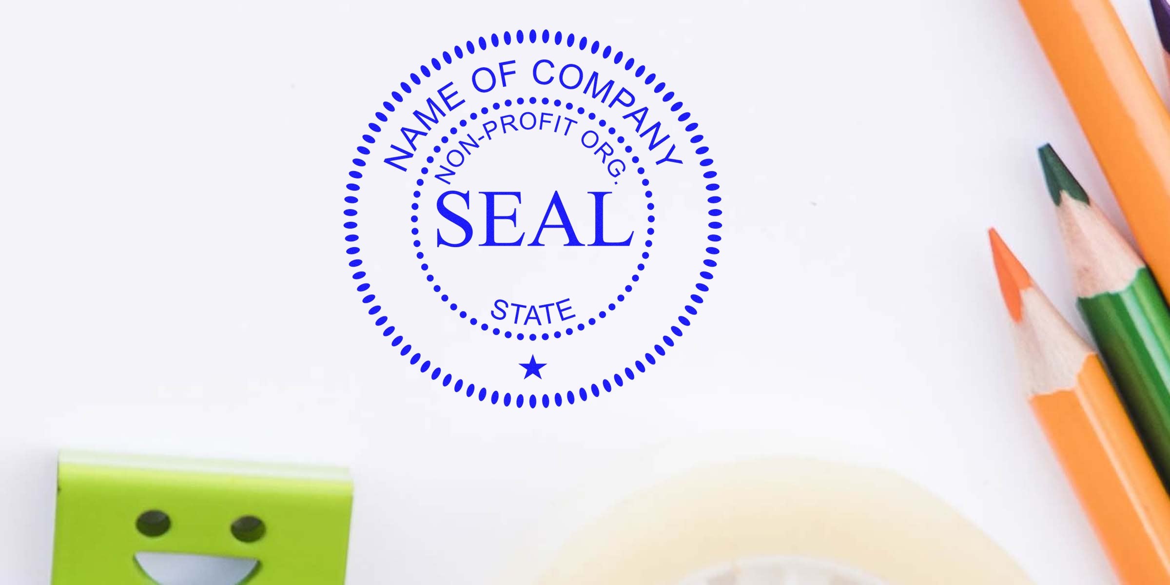 Blue circular seal stamp with the word SEAL in the center and STATE around the inner circle, surrounded by colored pencils and a green sticky note.