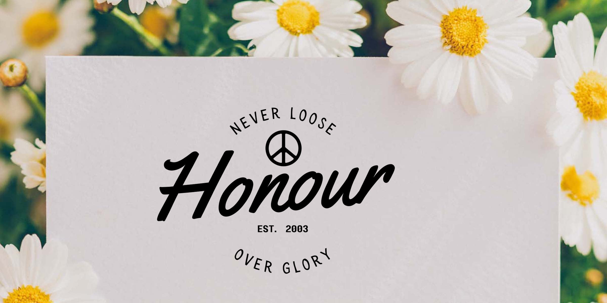 White daisies surrounding a blank textured card with vintage script "Honour", peace symbol and "Never loose over glory" slogan, soft green floral background, spring greeting card mockup