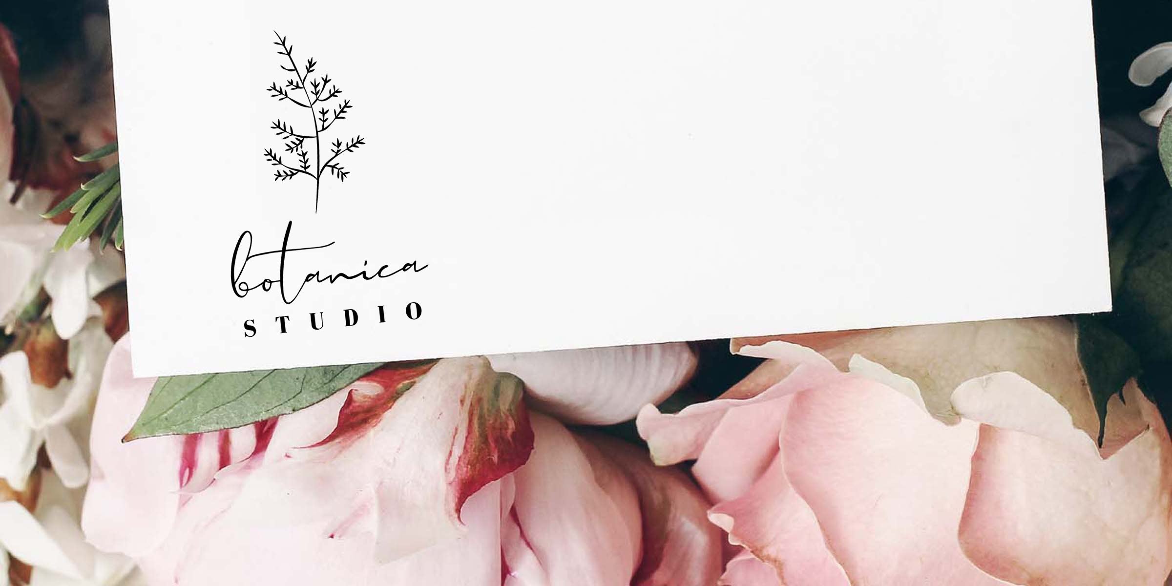 White business card with "Botanica Studio" logo (script "botanica" and stamped "STUDIO") resting on pink peony petals and green leaves, floral branding and soft pastel aesthetic.