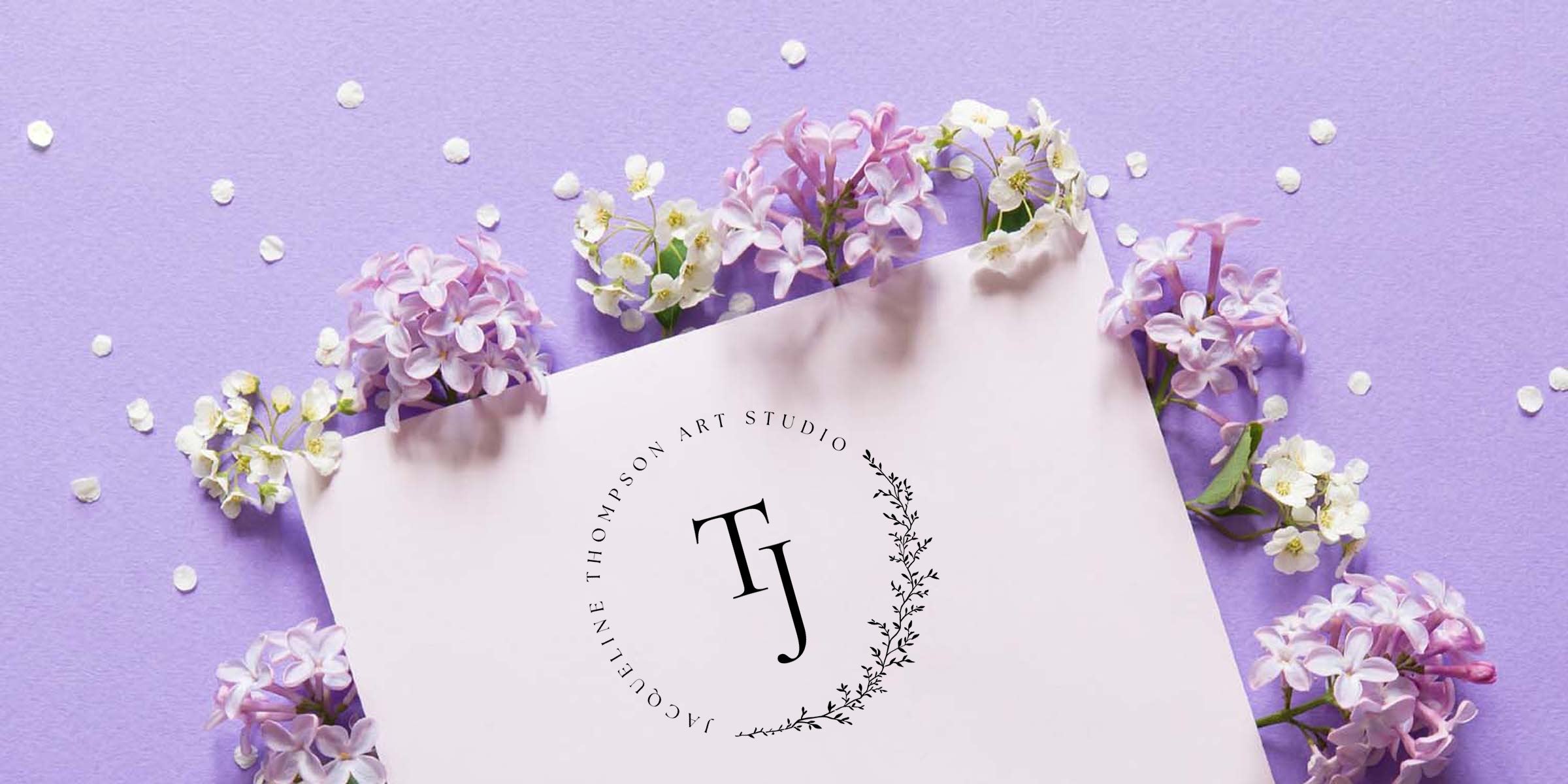 Pastel purple flatlay with lilac and white blossoms and scattered petals, pale pink card featuring a black circular monogram logo with initials TJ — elegant floral stationery and branding mockup for wedding invites or boutique art.