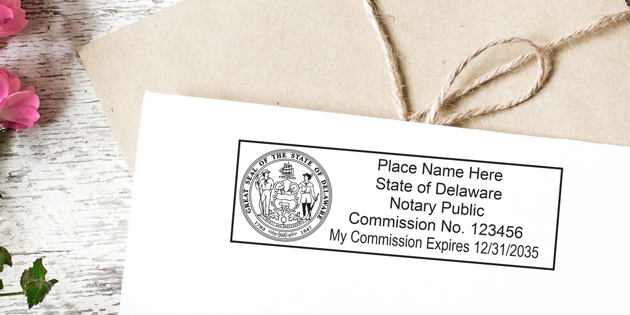 Delaware notary public rubber stamp mockup on envelope showing state seal, commission number and expiration date, rustic whitewashed wood background, twine-wrapped kraft paper and pink floral accents