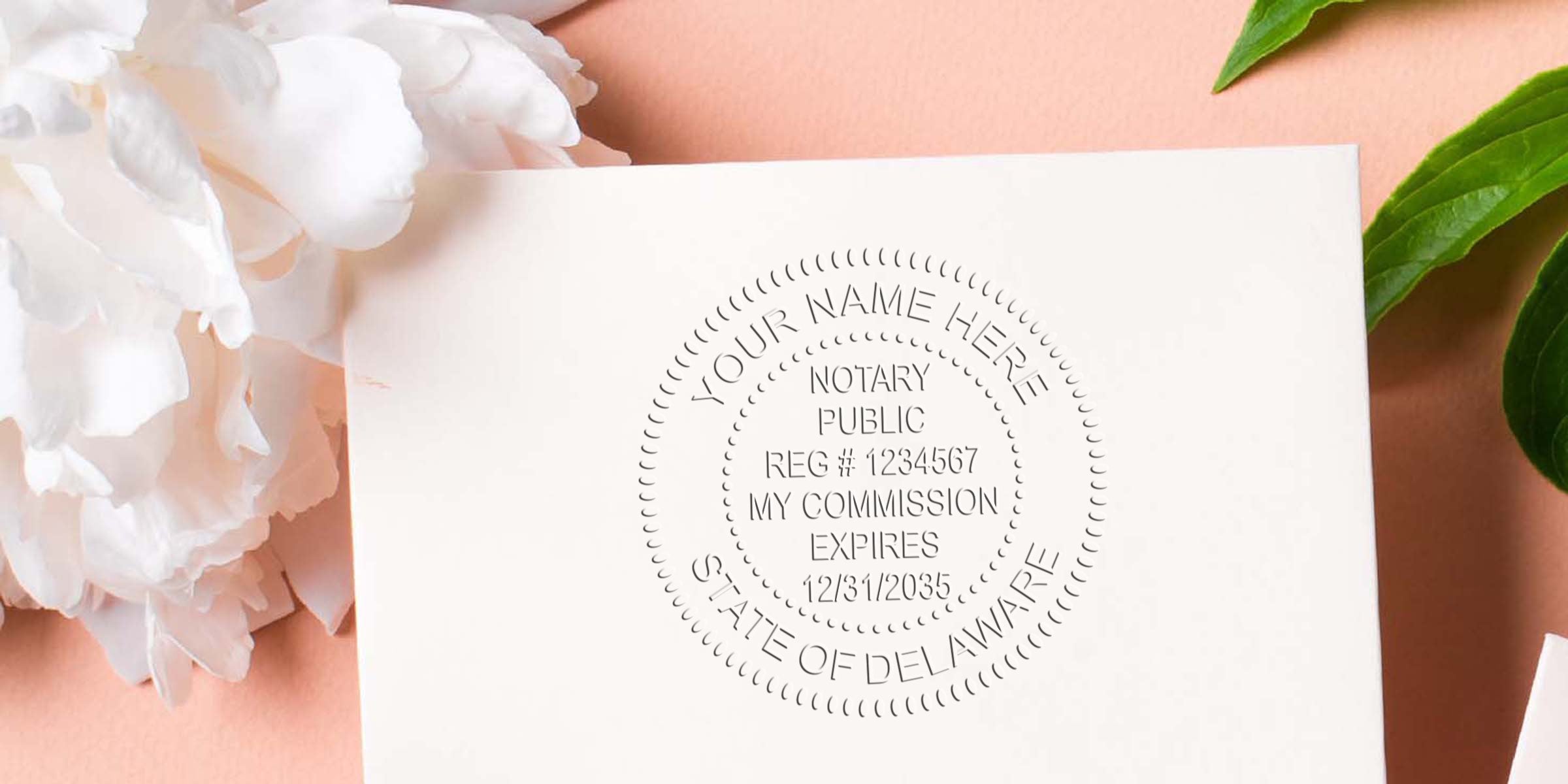 Embossed notary public seal impression on ivory stationery card reading "State of Delaware," styled flatlay with white peony flower and green leaf on a soft peach background, showcasing custom notary embosser stationery design.