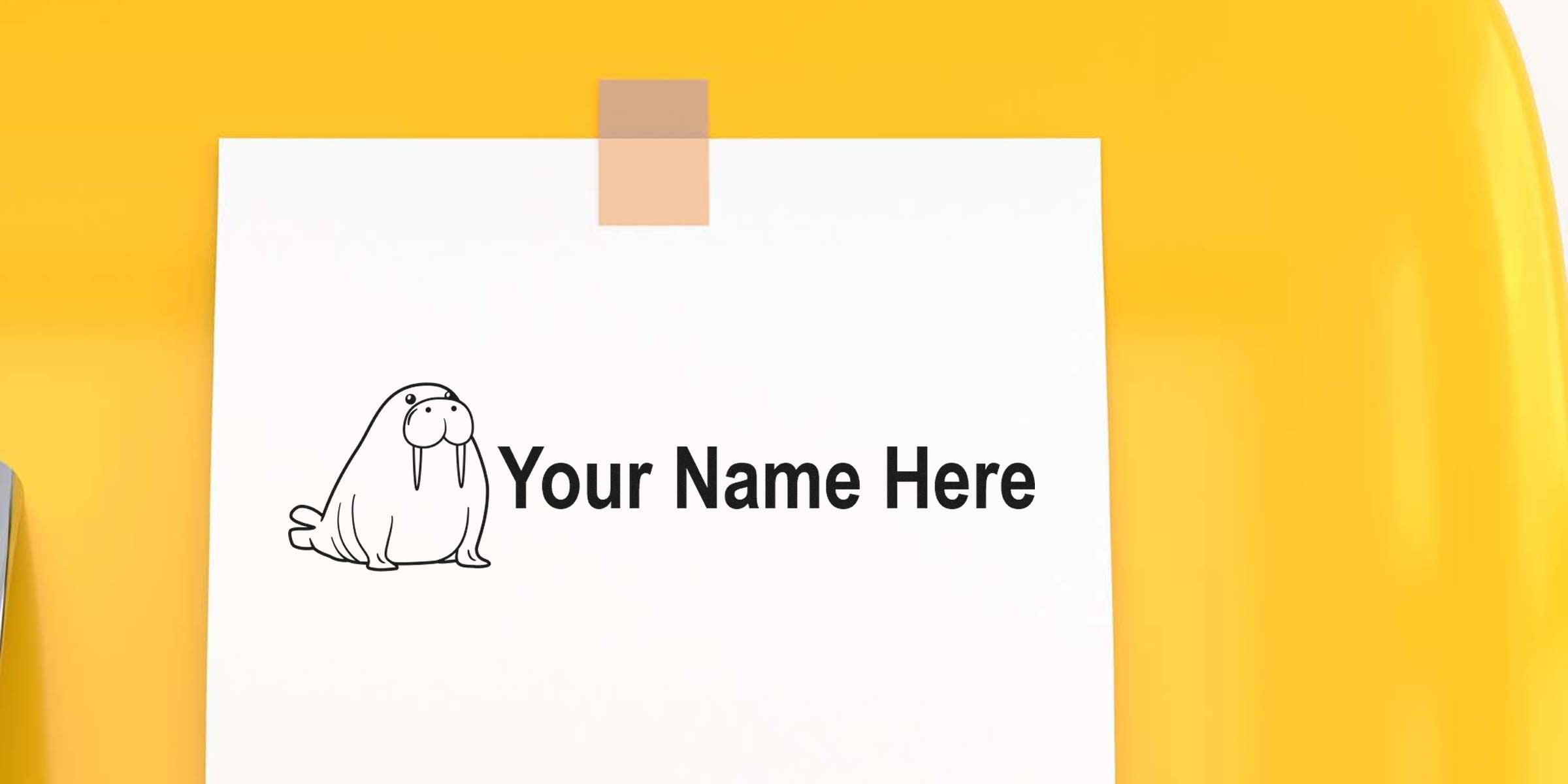 White card with the words 'Your Name Here' and a cartoon walrus on the left, taped to a yellow background.