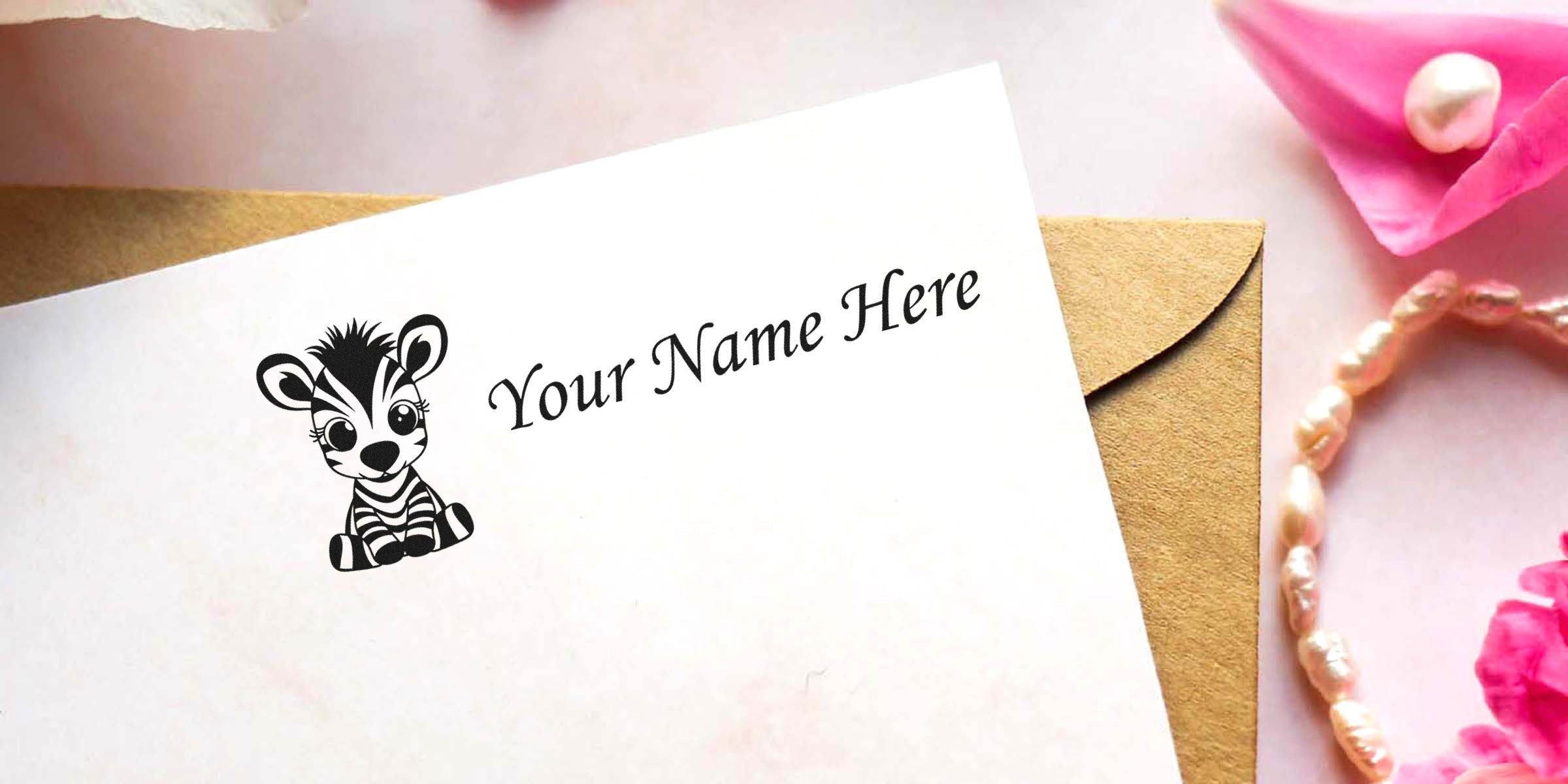 Card with a zebra illustration and the text “Your Name Here” on a white card beside a brown envelope.