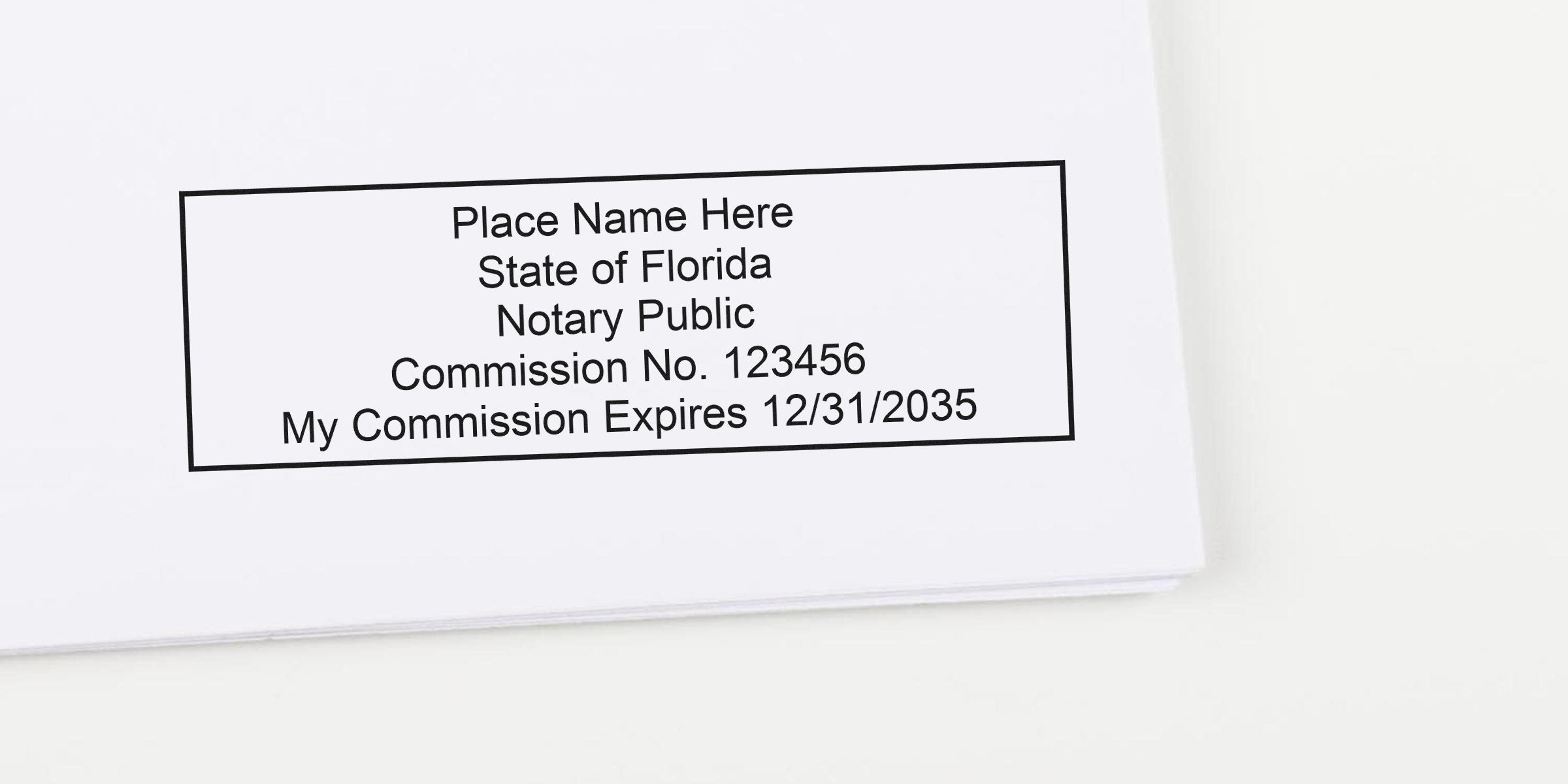 Sample rectangular Florida notary public stamp on white paper reading "Place Name Here, State of Florida, Notary Public, Commission No. 123456, My Commission Expires 12/31/2035"