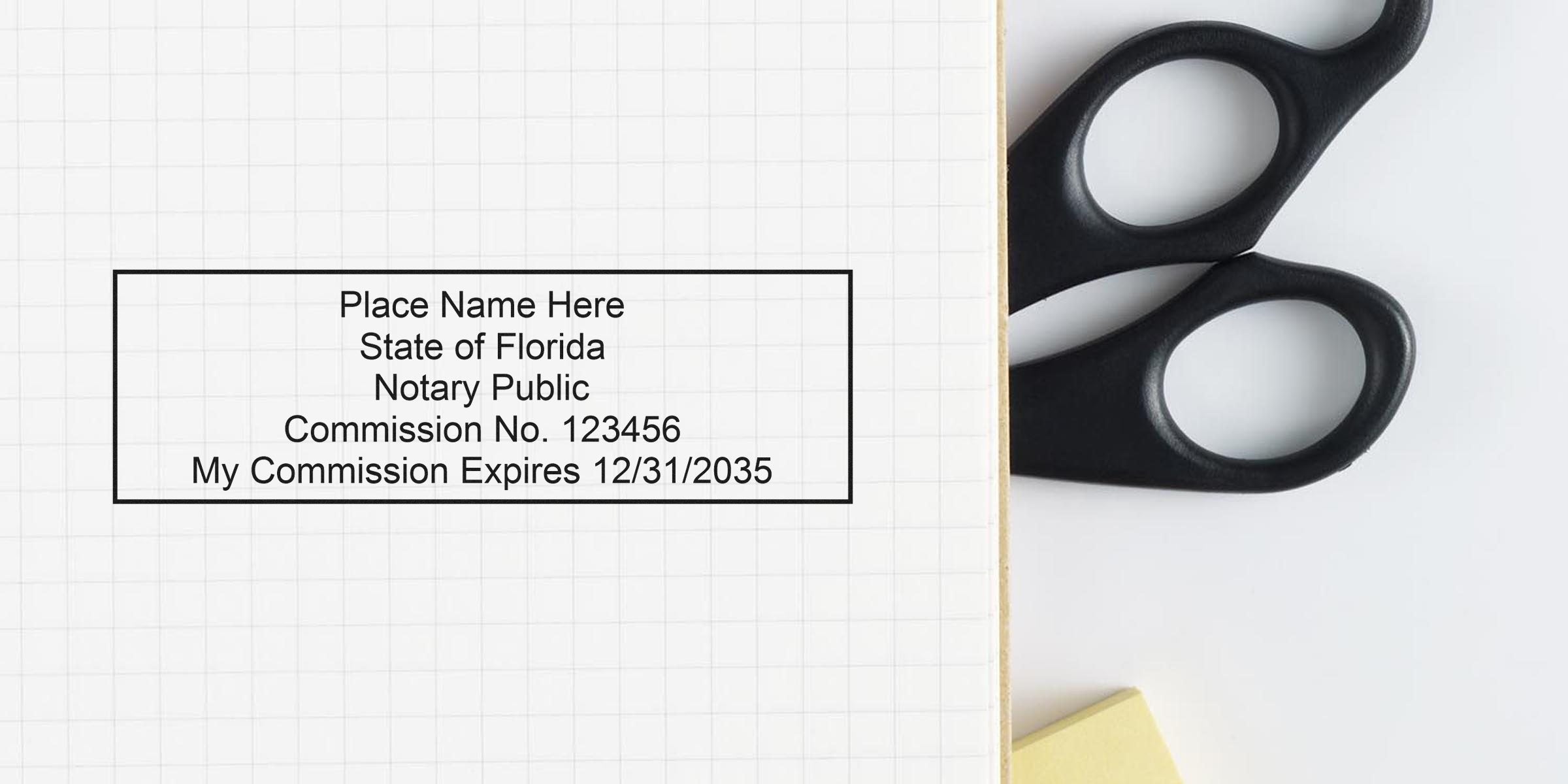 Notary stamp mockup on grid paper reading "Place Name Here, State of Florida, Notary Public, Commission No. 123456, My Commission Expires 12/31/2035" with black-handled scissors and a yellow sticky note at the edge