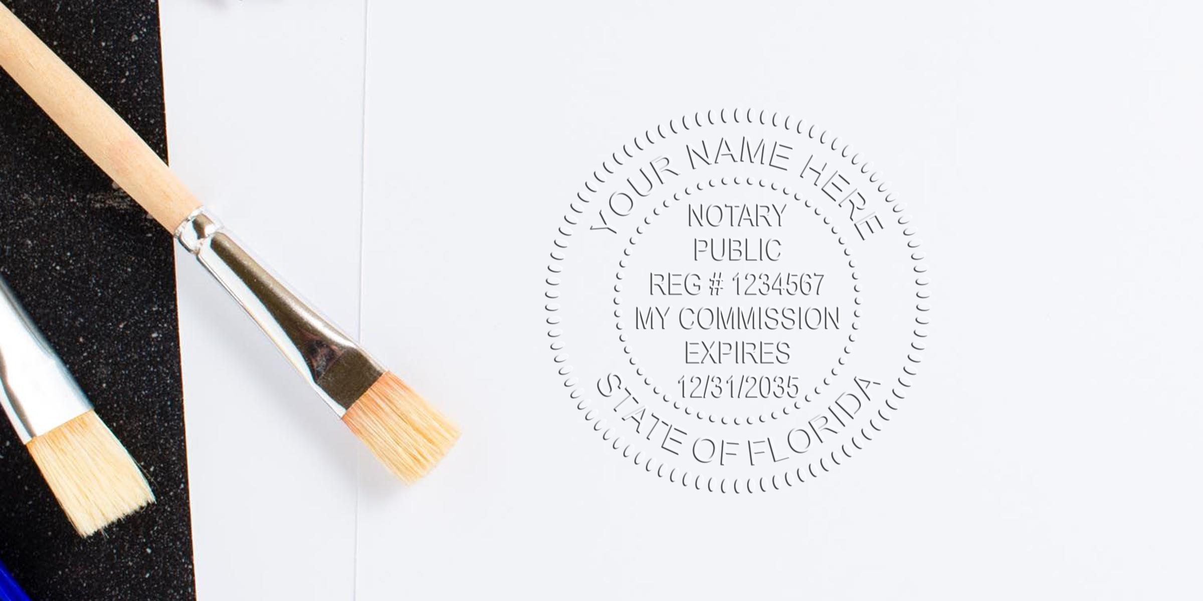 Embossed notary public seal impression on white paper reading "Your Name Here, Notary Public, State of Florida" beside two wooden-handled paintbrushes on a black and white background