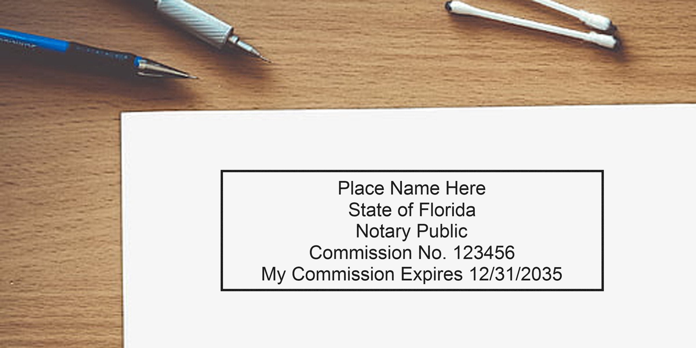 Florida notary stamp template on paper reading "Place Name Here, State of Florida Notary Public, Commission No. 123456, My Commission Expires 12/31/2035" on wooden desk with pens