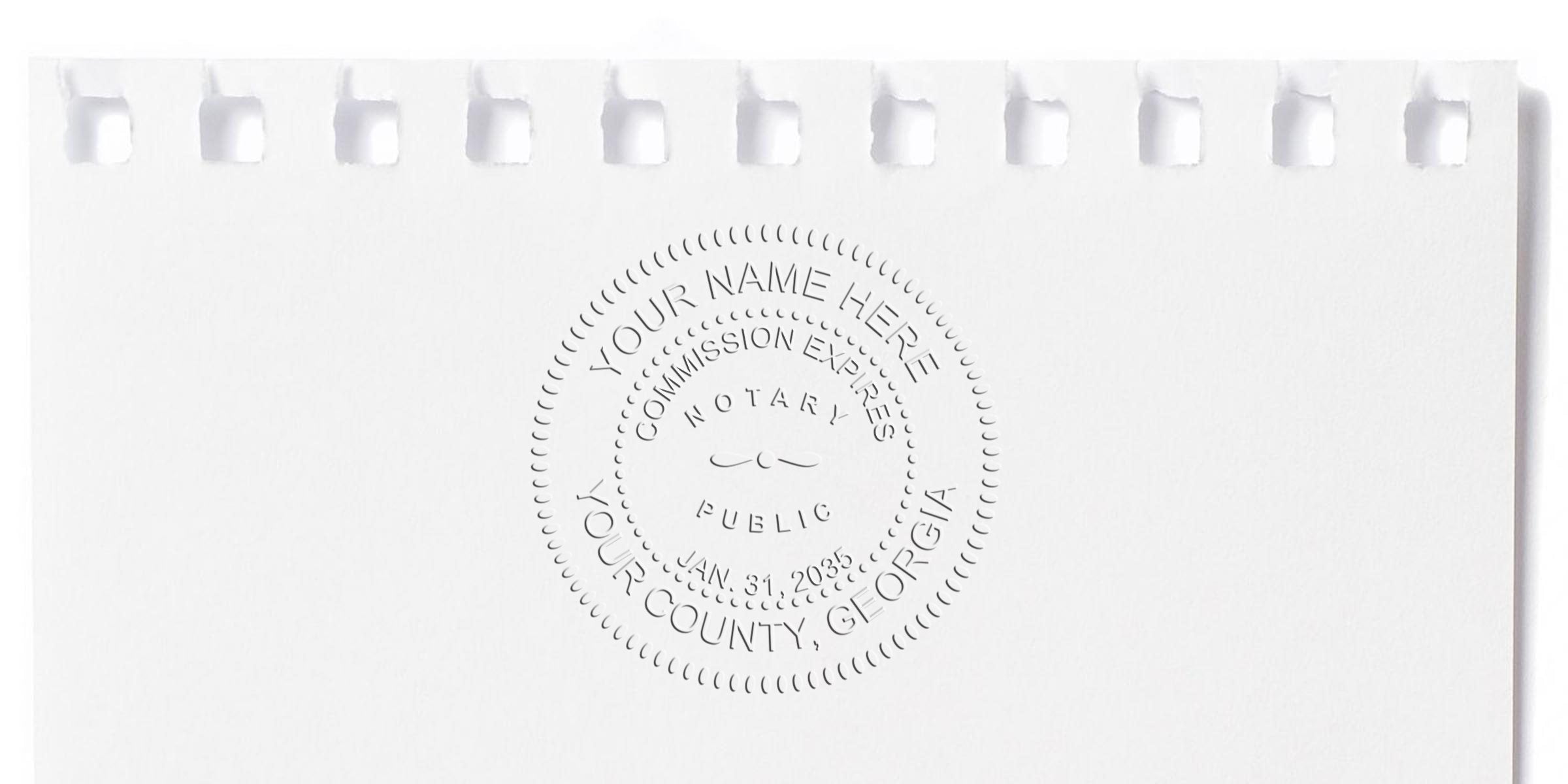 White embossed notary seal reading "YOUR NAME HERE, COMMISSION EXPIRES, NOTARY PUBLIC, YOUR COUNTY, GEORGIA" centered on white torn spiral notebook paper with perforated top edge