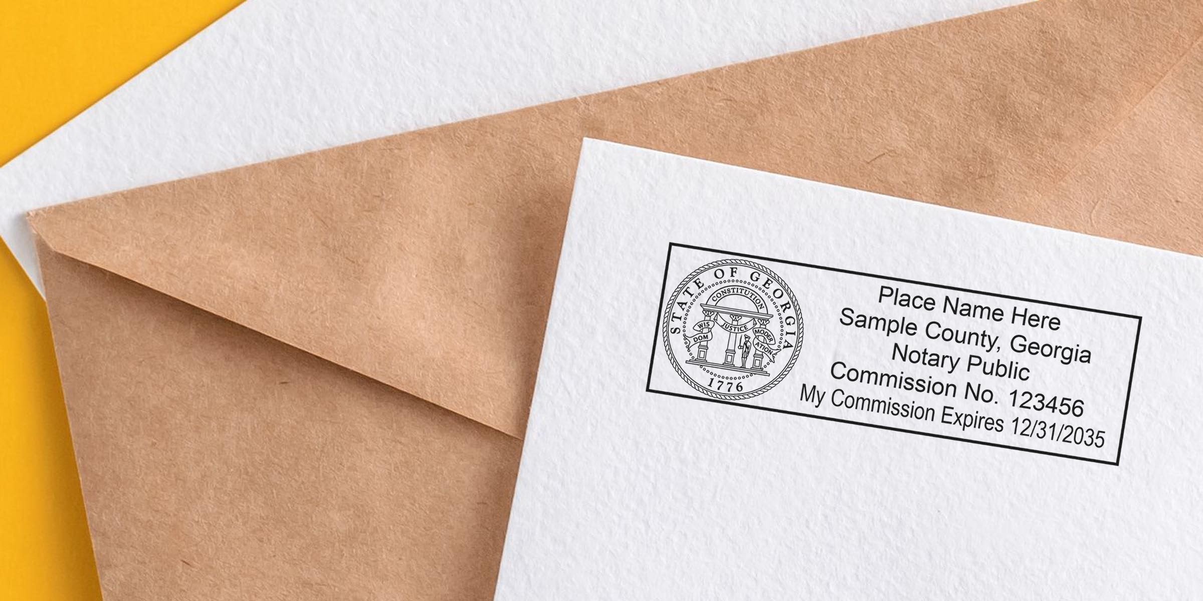 Brown kraft envelope and white stationery showing a Georgia notary public stamp sample with state seal, commission number and expiration date