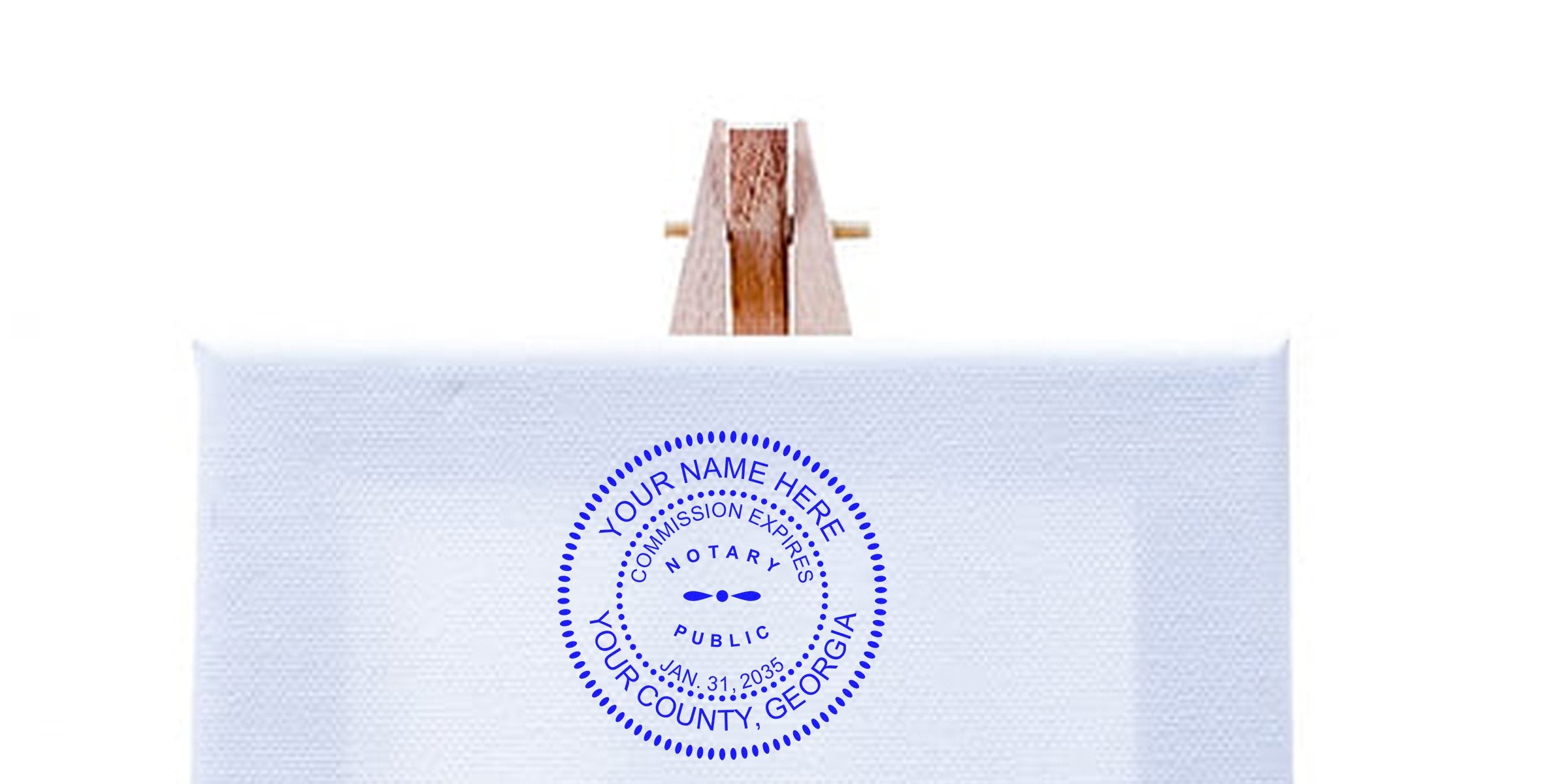 Blank white stretched canvas on a small wooden easel displaying a blue circular notary public seal stamp reading "Your Name Here, Your County, Georgia."