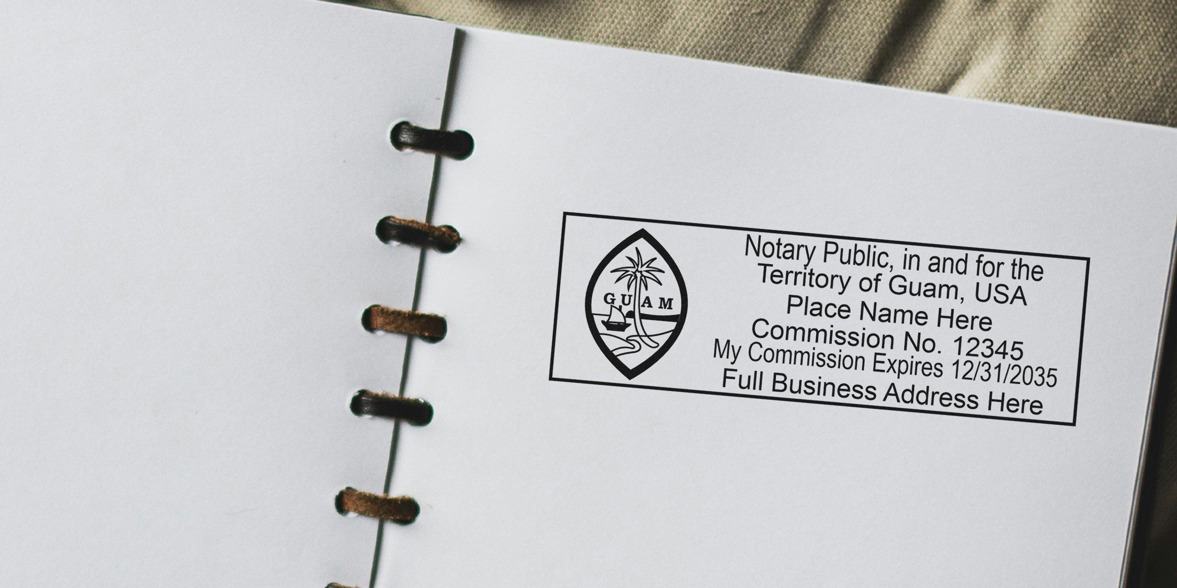 Close-up of a Guam notary public stamp imprint on a white spiral-bound notebook page showing the Guam seal, commission number, expiration date and placeholder business address — notary stamp for legal document authentication
