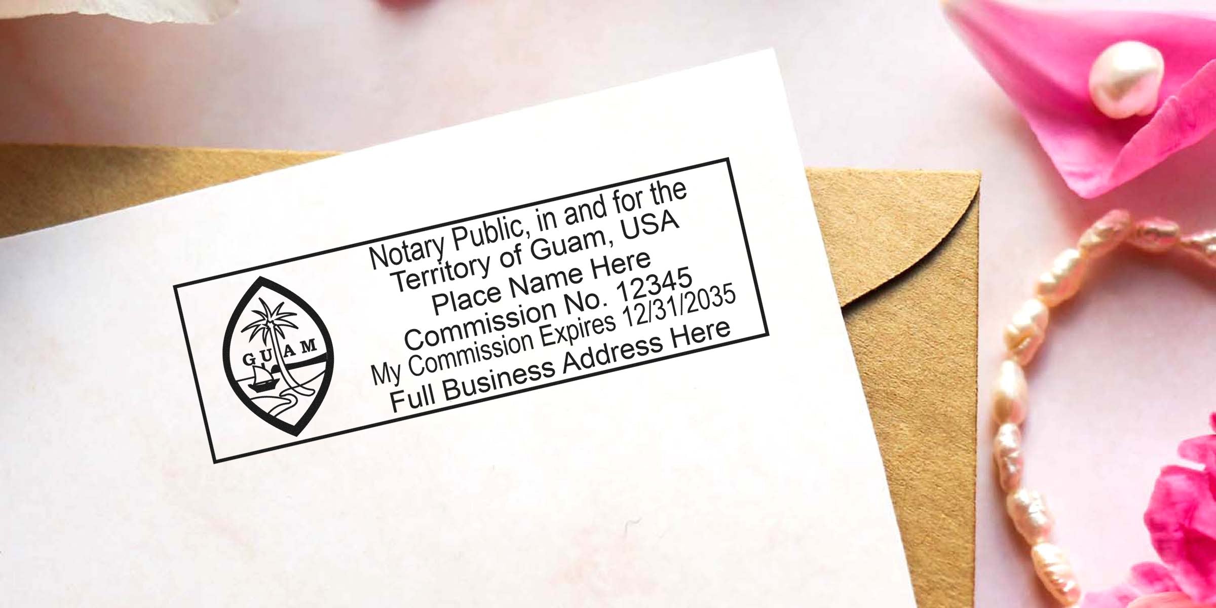 Guam notary public rubber stamp imprint on white paper showing commission number, expiration date and business address placeholder, placed on a kraft envelope with pink flowers and a pearl bracelet nearby