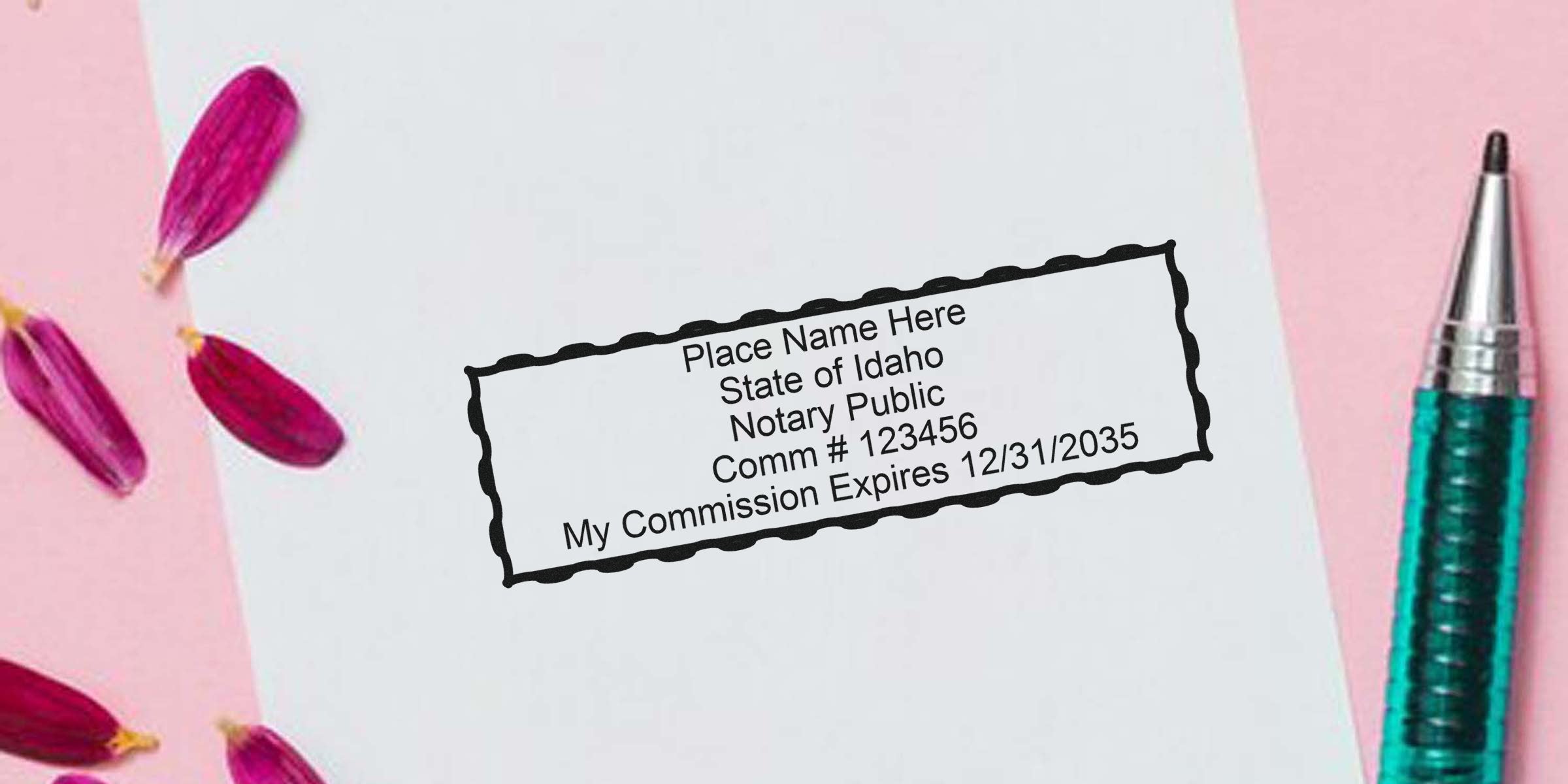 Rectangular notary stamp impression on white paper reading "State of Idaho Notary Public, Comm #123456, My Commission Expires 12/31/2035" with teal pen and pink flower petals on pink background