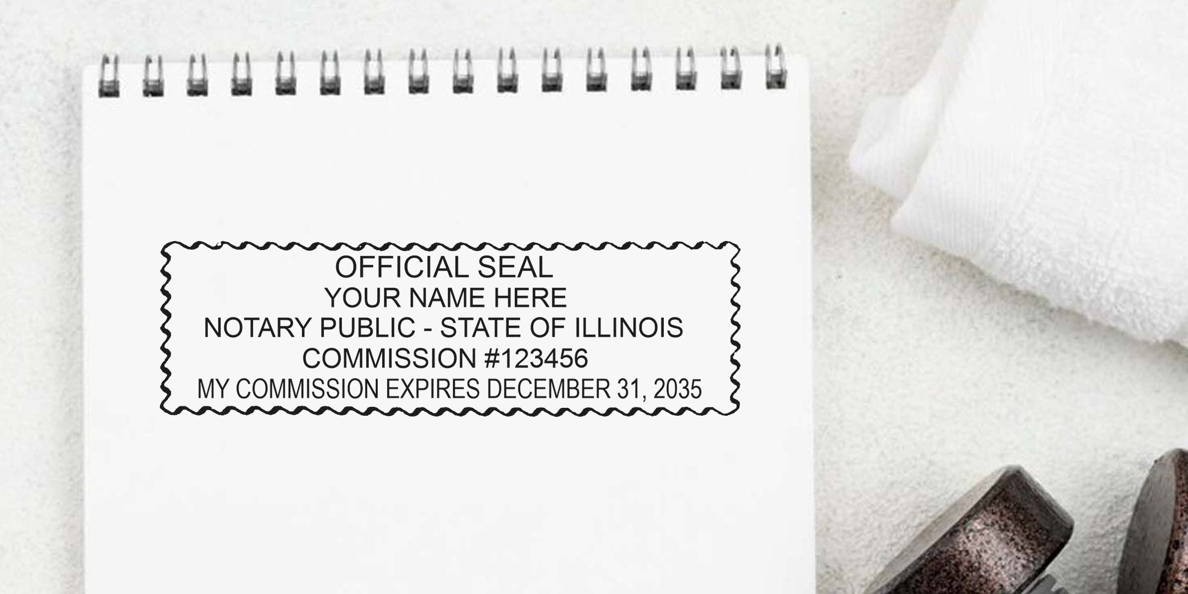 Spiral notebook page showing a black wavy-bordered notary public seal mockup reading: "Official Seal, Your Name Here, Notary Public - State of Illinois, Commission #123456, My commission expires December 31, 2035."