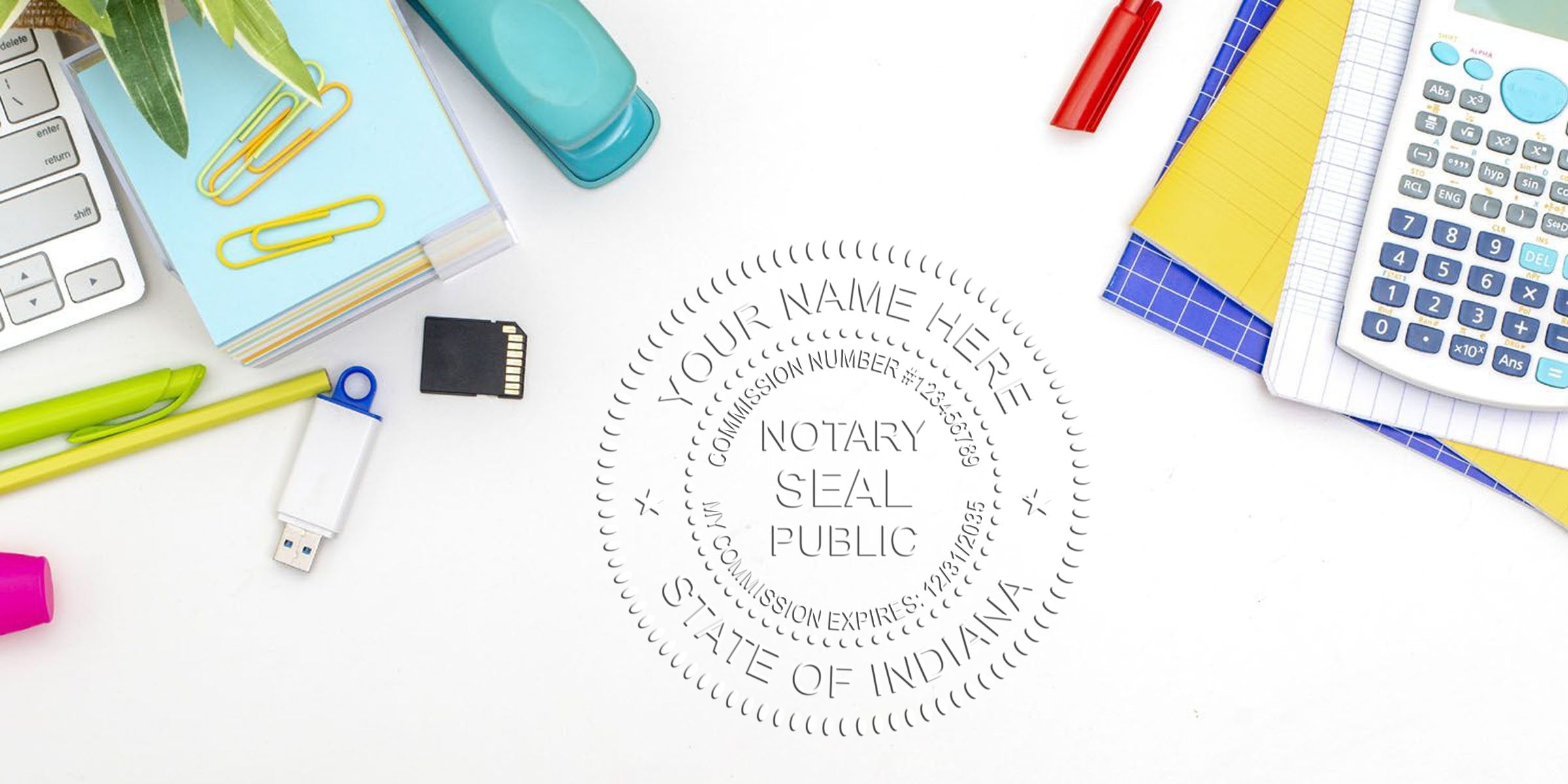 Flat lay of white desk with embossed notary seal (State of Indiana) surrounded by colorful office supplies: calculator, keyboard, stapler, pens, USB drive, SD card, paper clips and notepads.