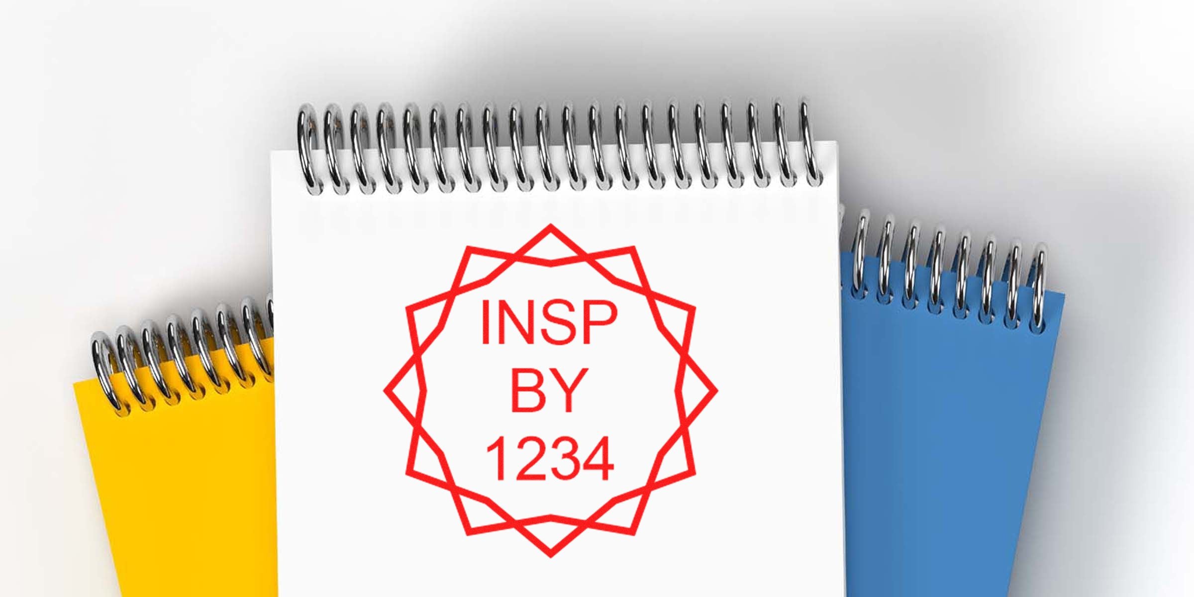 Notebook with a red geometric stamp reading "INSP BY 1234."