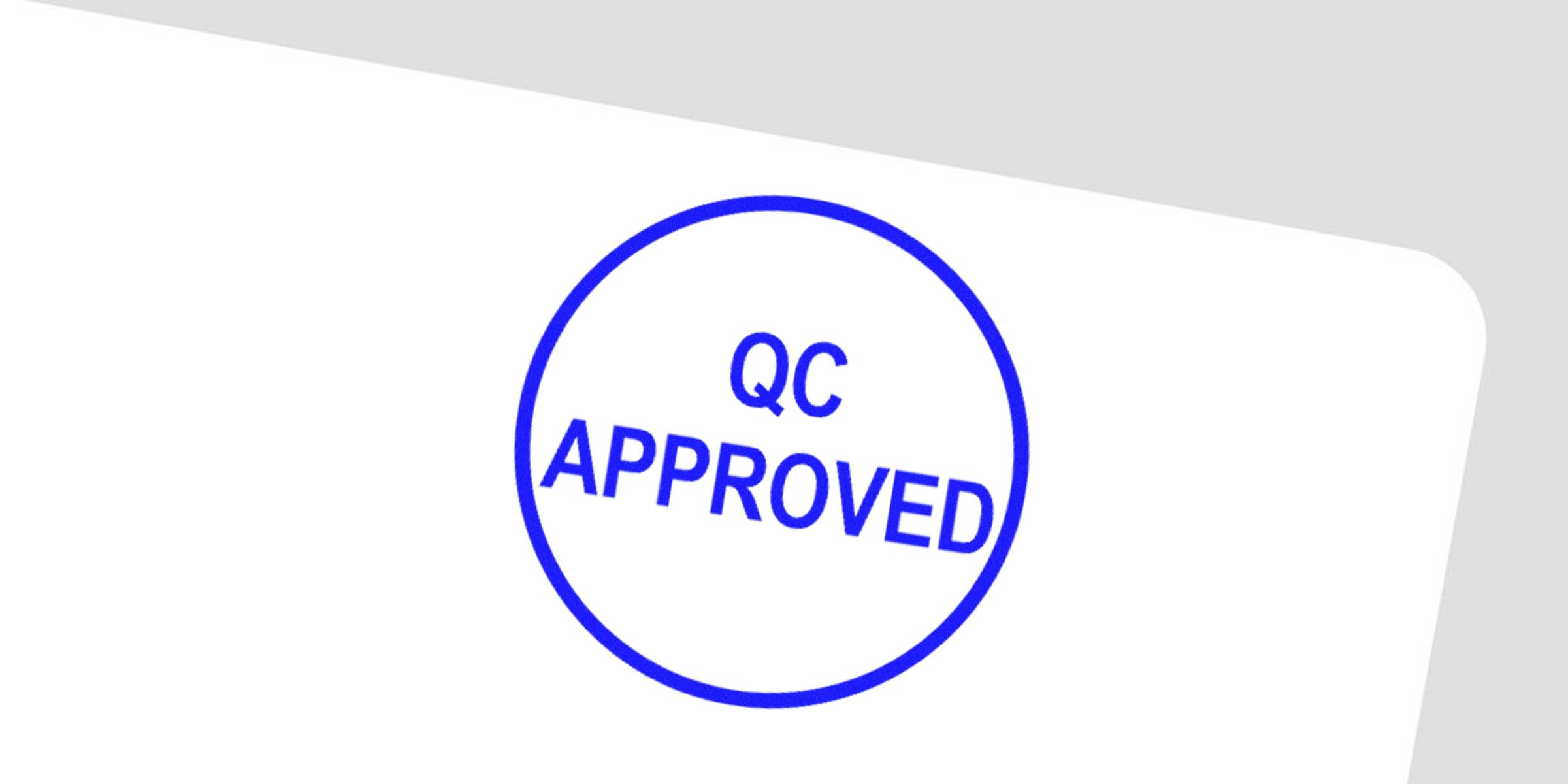 Circular blue stamp reading "QC APPROVED" on a white background.