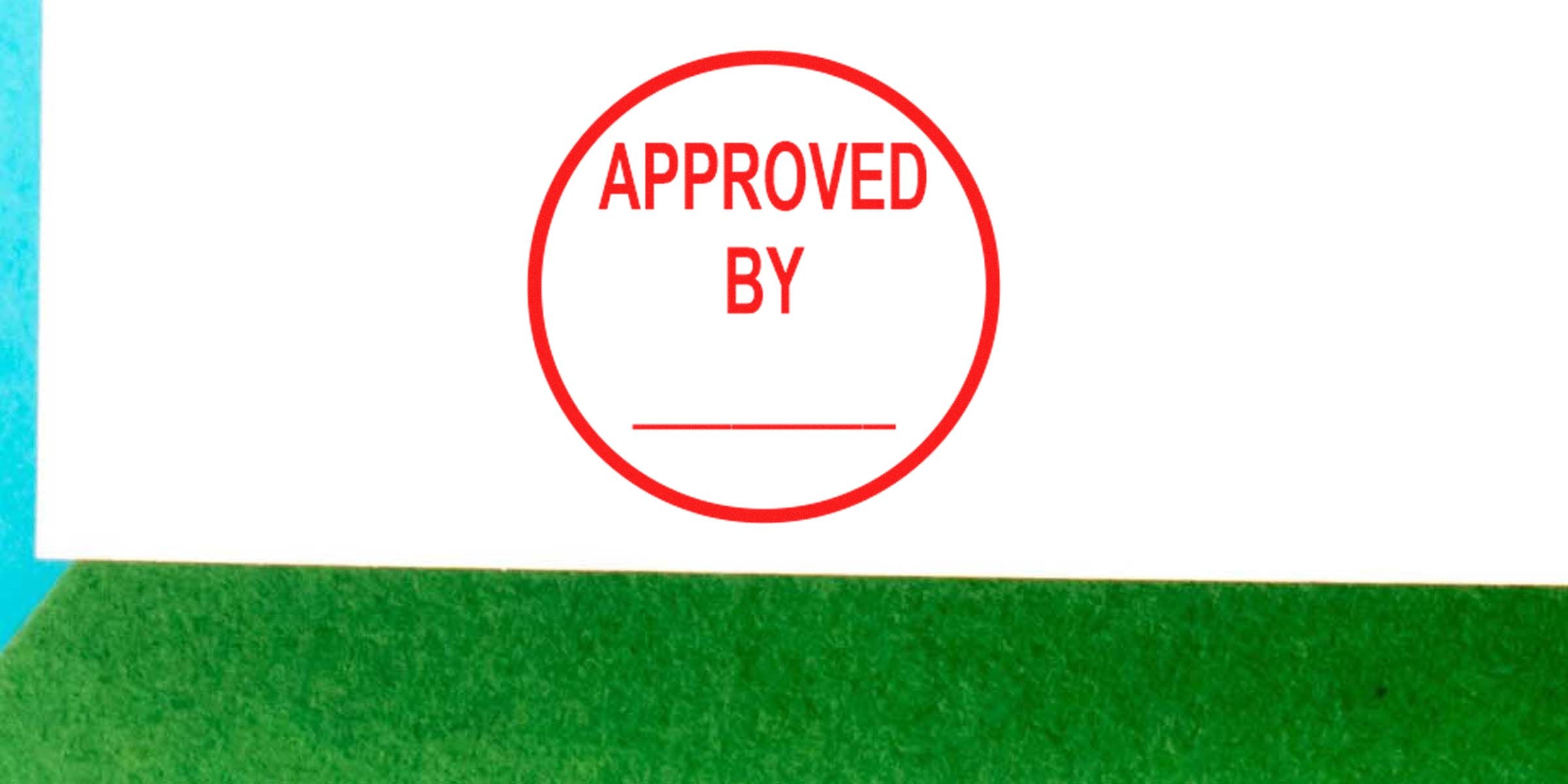 Red circular stamp with the words “APPROVED BY” in red on white background.