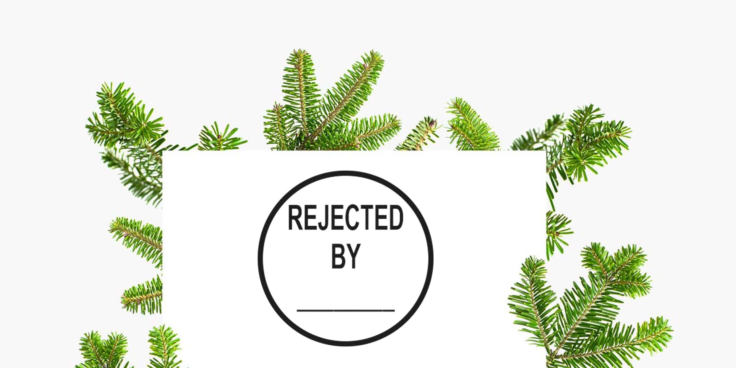 Circular stamp reading "REJECTED BY" on a white card, surrounded by green pine branches.