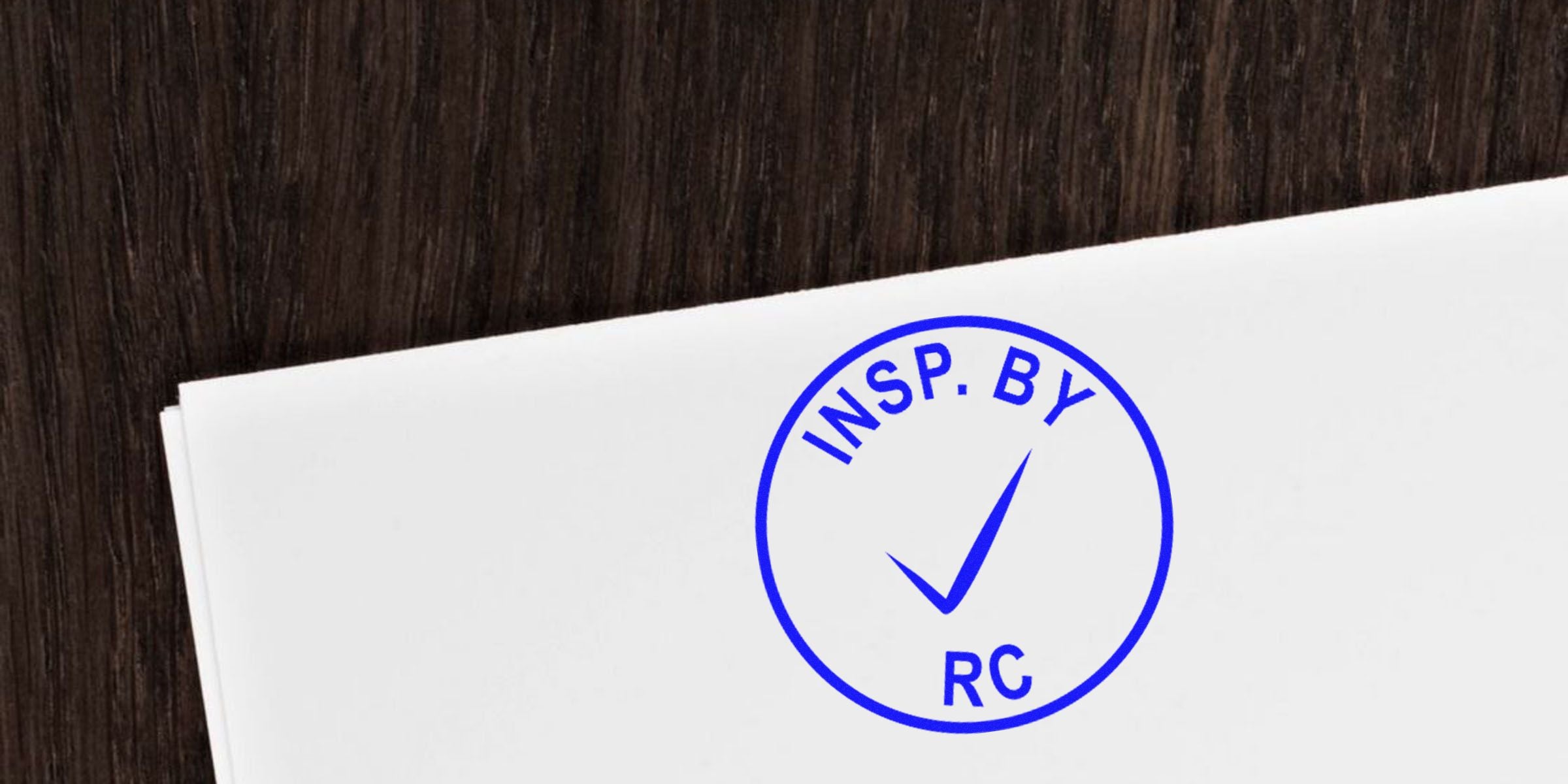 Blue circular stamp with a checkmark and the text INSP. BY RC.