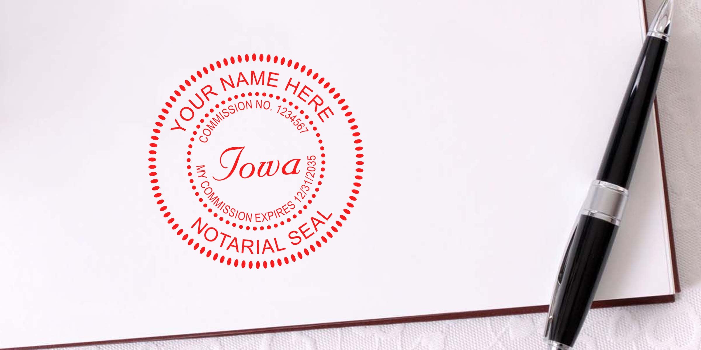 Red circular Iowa notarial seal stamped on white paper beside a black pen, official notary stamp for documents