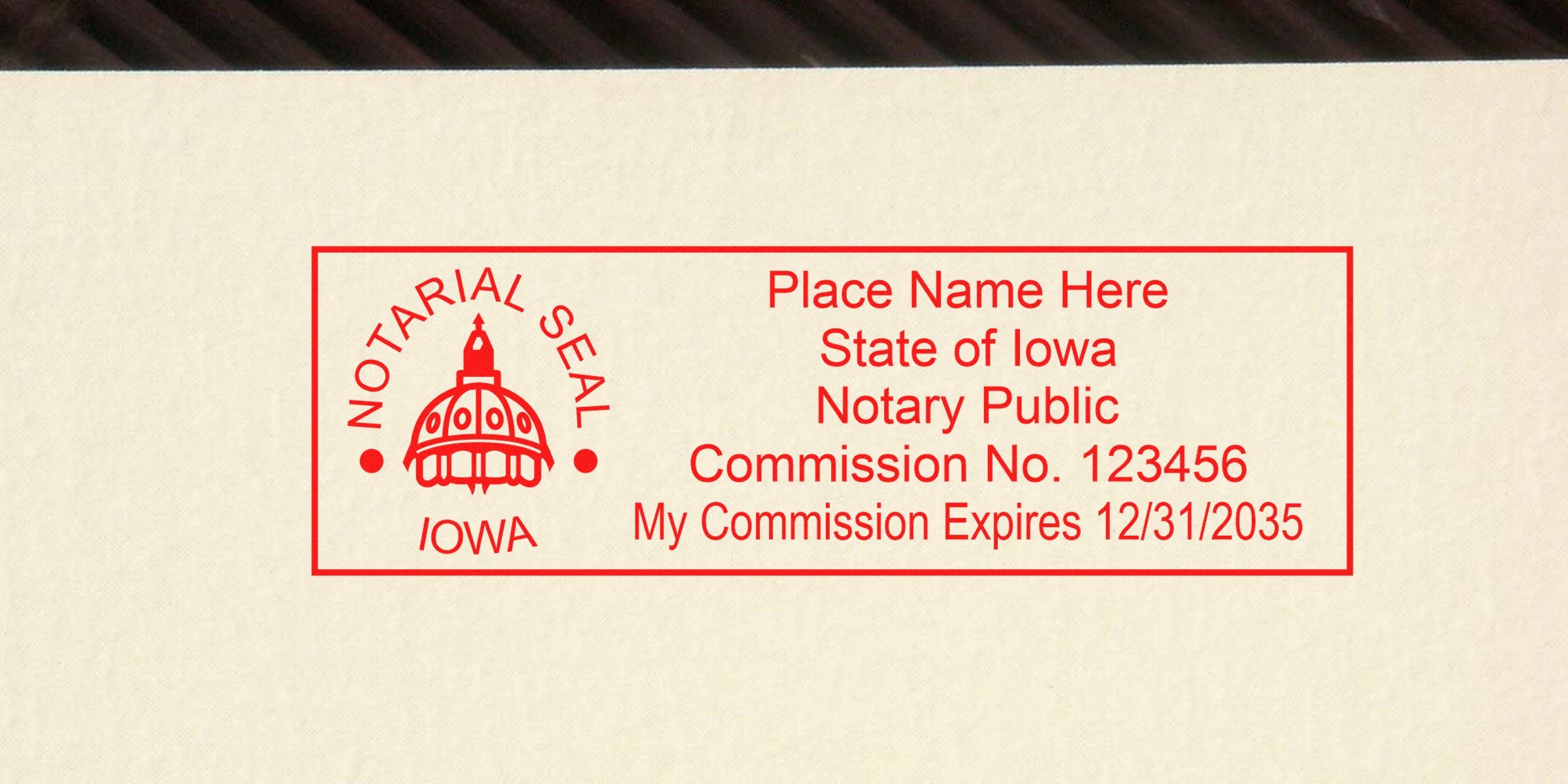 Red rectangular Iowa notary seal stamp sample with capitol dome logo, placeholder name, commission no. 123456 and expiration 12/31/2035.
