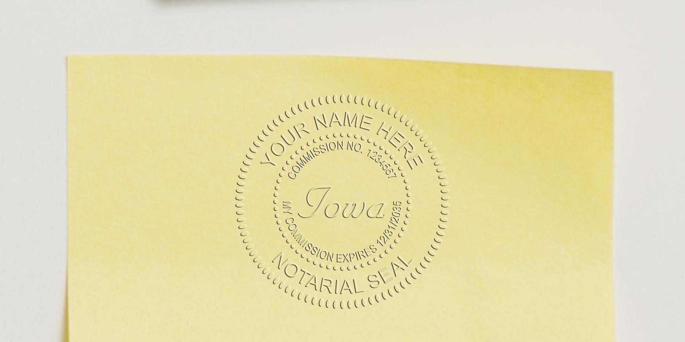 Embossed Iowa notary seal on yellow paper reading "Your Name Here", "Commission No. 1234567", and "Notarial Seal" — circular official embossing for notary public documents.