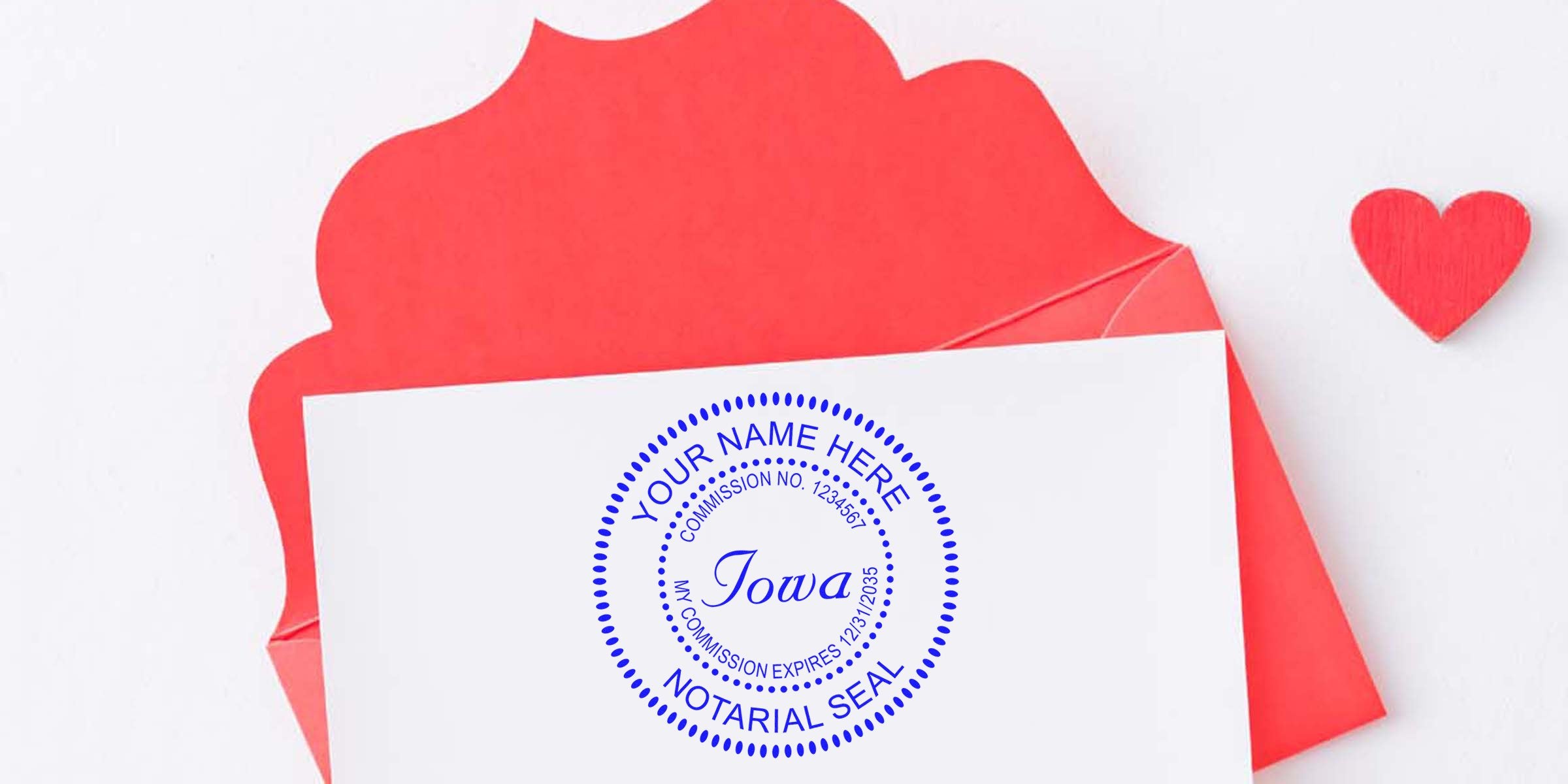 White card stamped with a blue circular Iowa notarial seal, resting on a partially open red envelope with a small red heart on a white background