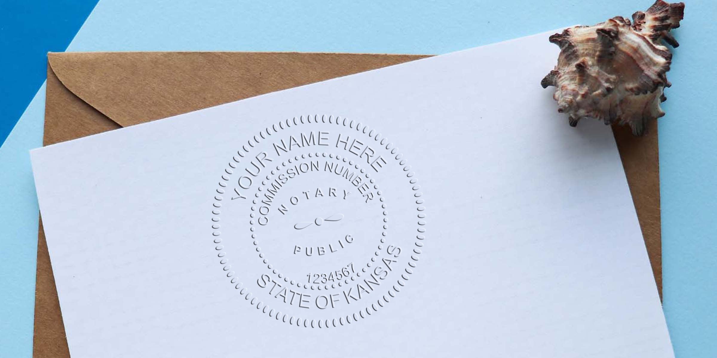 Embossed notary public seal on white stationery reading "State of Kansas" over a brown kraft envelope, photographed with a decorative seashell on a blue background — notary seal embossing, official document stationery.