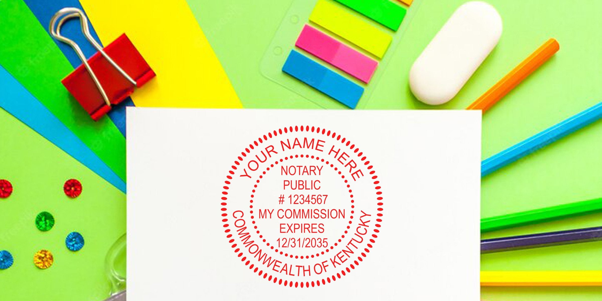 Red circular notary seal stamp on white paper reading "Notary Public" and "Commonwealth of Kentucky" surrounded by colorful stationery: binder clip, eras er, sticky tabs, pencils and decorative sequins on bright green background.