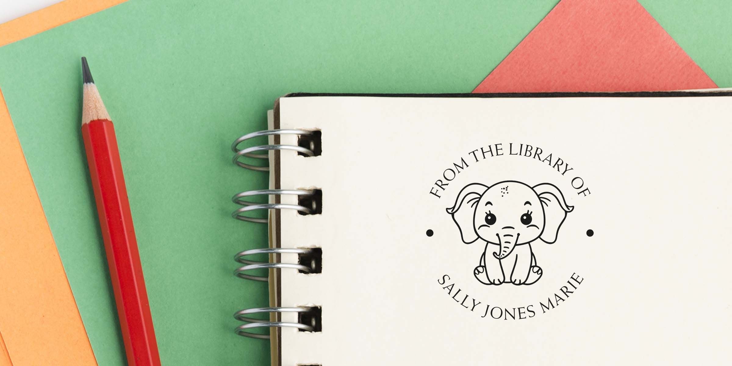 Notebook with a cute elephant logo and the text “From the Library Of Sally Jones Marie” on a colorful background.