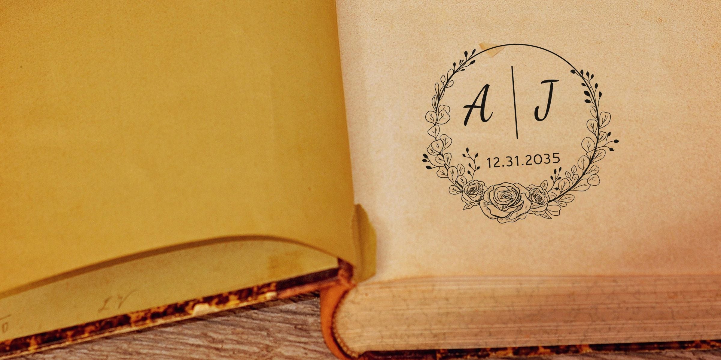 Open vintage book with a decorative circular floral wreath featuring the initials A and J and the date 12.31.2035.