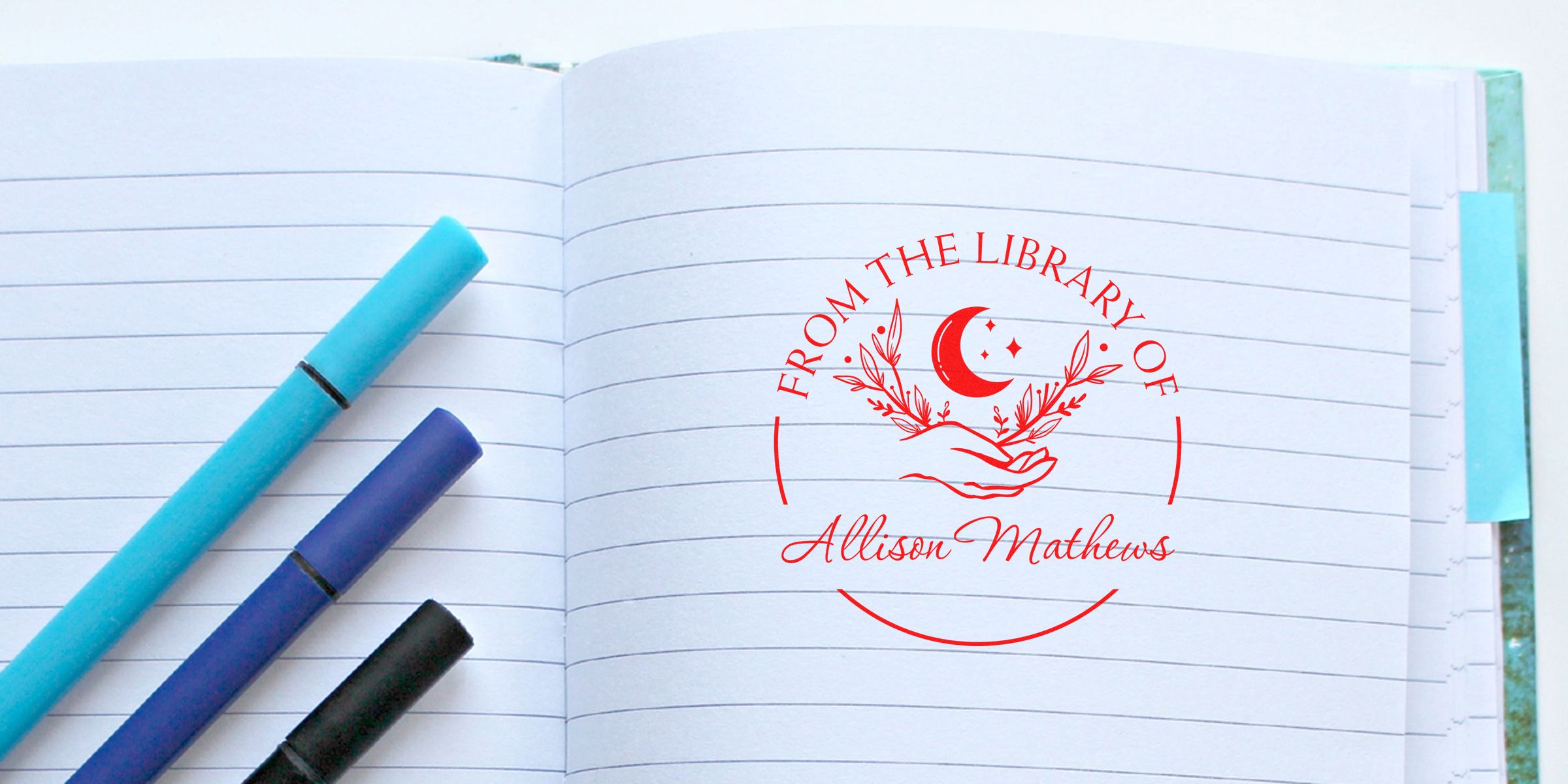 Logo reading “From the Library of Allison Mathews” with a crescent moon and decorative branches, centered on an open notebook with colored markers.