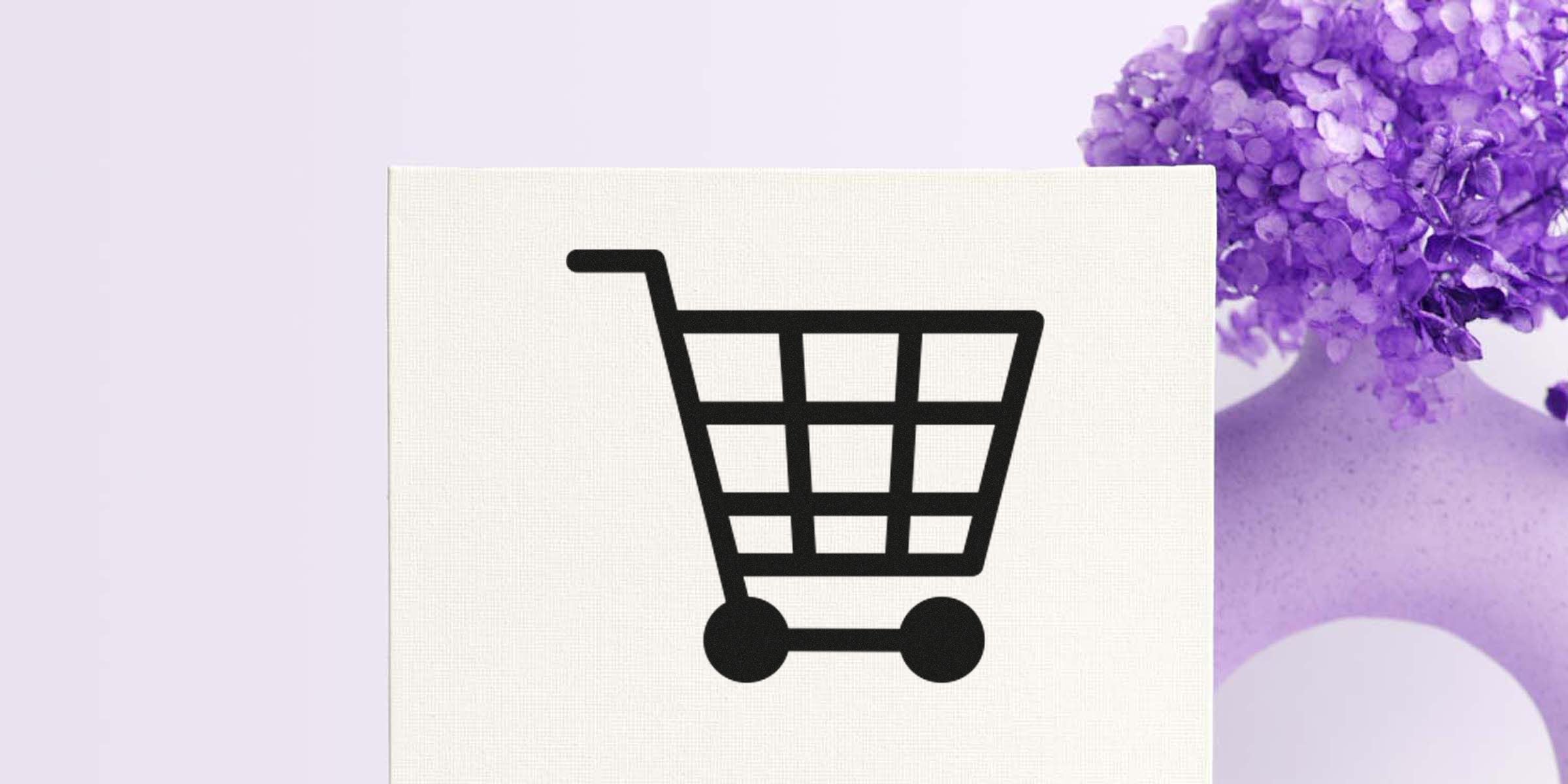 Black shopping cart icon on a light, textured background.