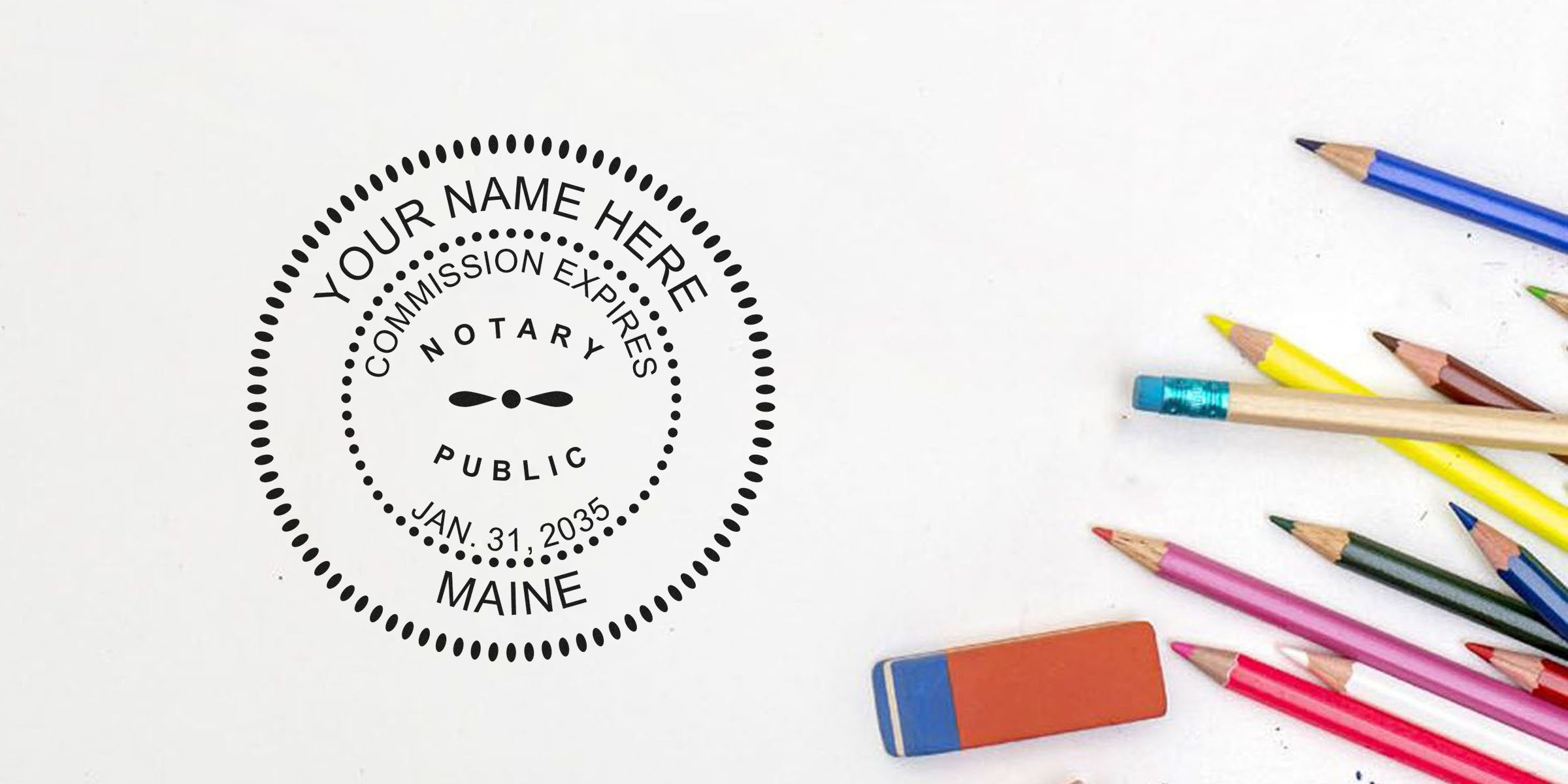 Notary public circular stamp mockup reading "Your Name Here, Commission Expires Jan. 31, 2035, Maine" on white paper beside colored pencils and eraser, stationery flatlay