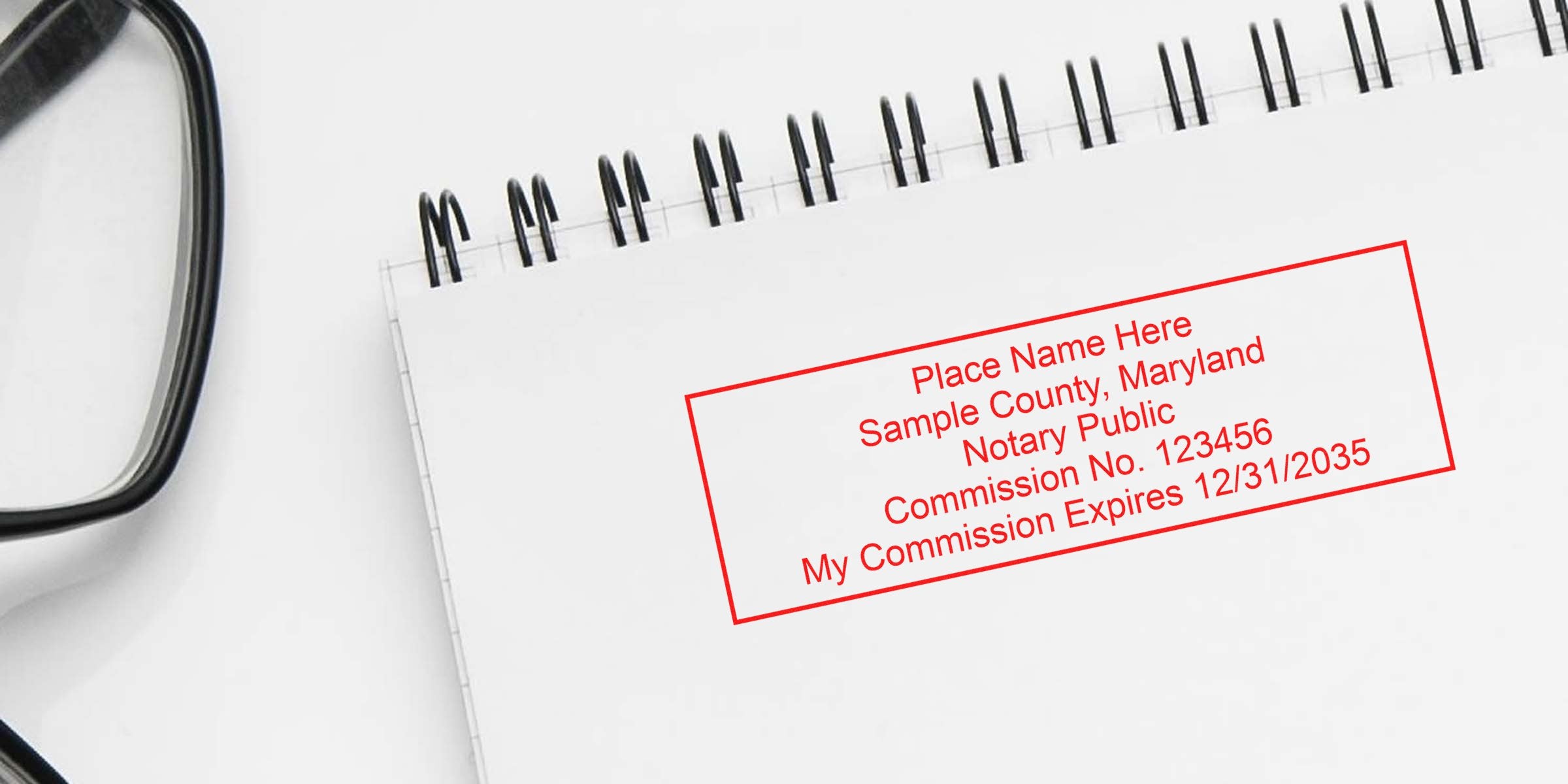 Red rectangular notary stamp mockup reading "Place Name Here Sample County, Maryland Notary Public Commission No. 123456 My Commission Expires 12/31/2035" stamped on a spiral notebook page with eyeglasses at left