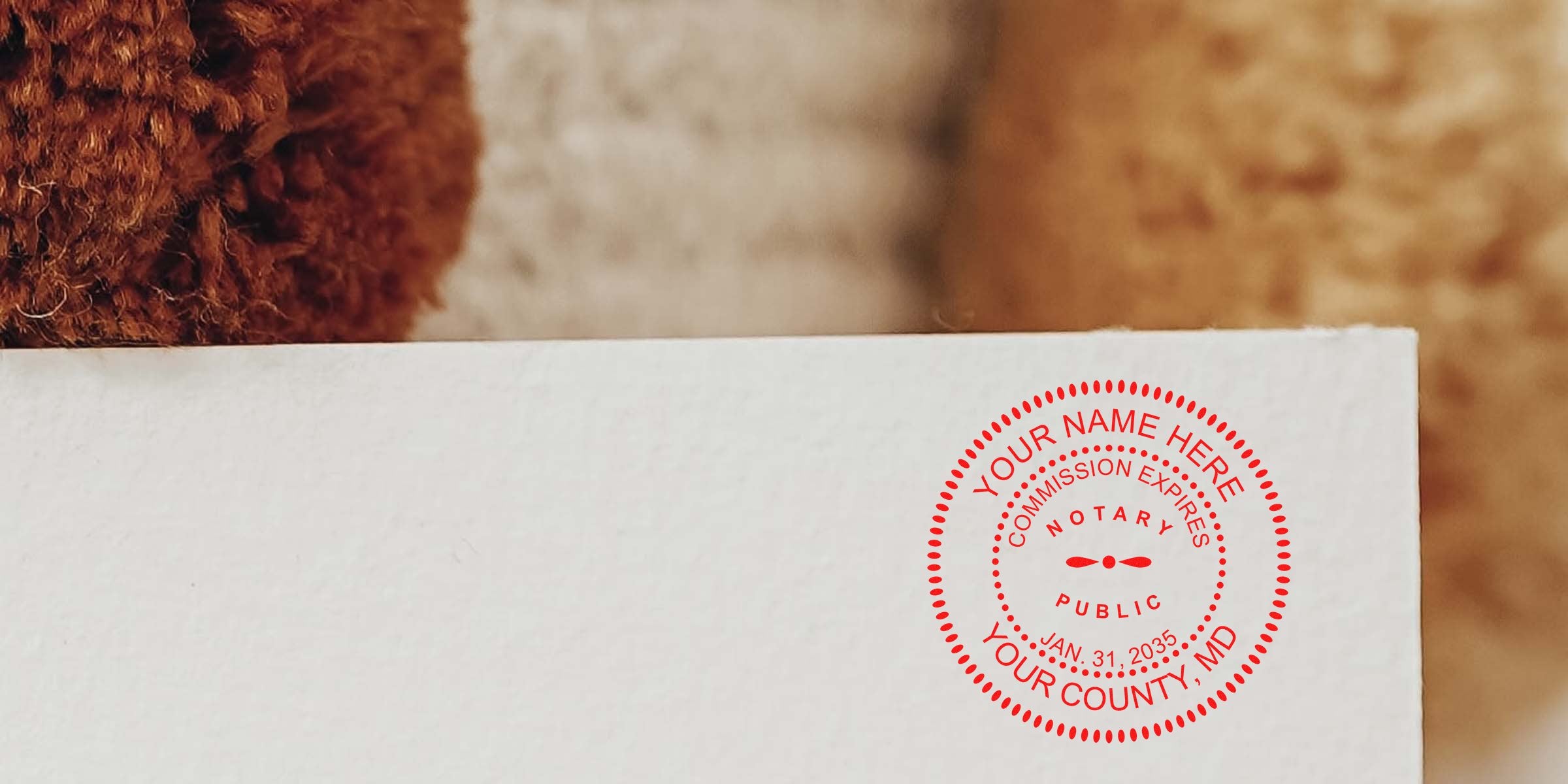 Close-up of a red notary public seal stamp on a white envelope corner with textured brown background — notary stamp, notary seal, mail, legal document authentication.