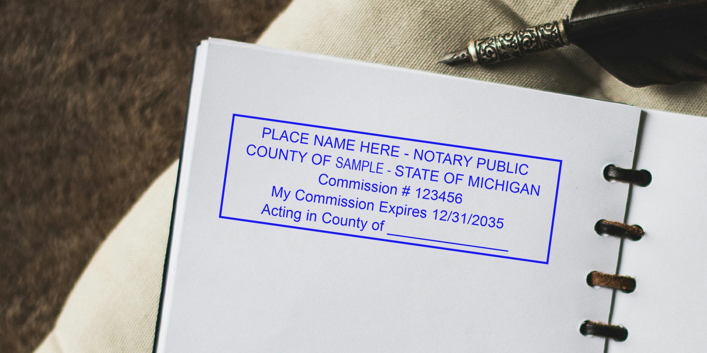 Blue notary public stamp mockup on a white notebook page reading "County of Sample - State of Michigan" beside an ornate fountain pen